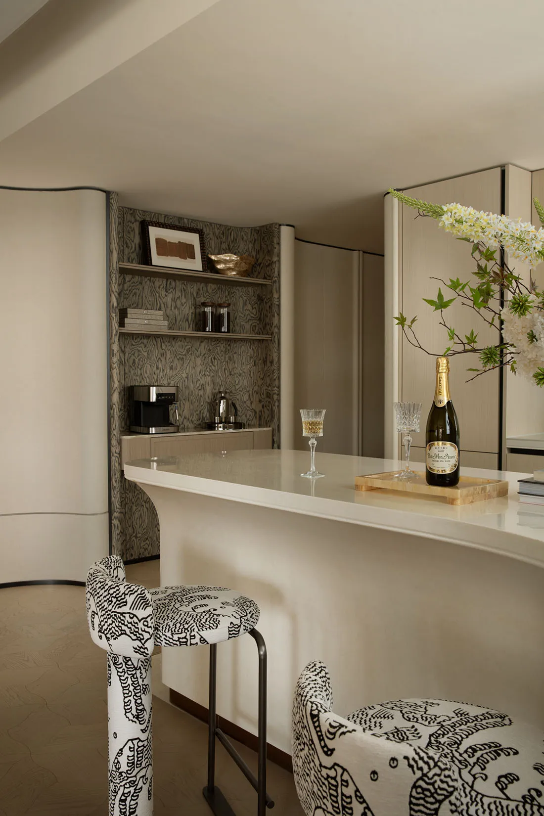 A sleek modern kitchen bar in a contemporary style, featuring minimalist white finishes and clean lines.