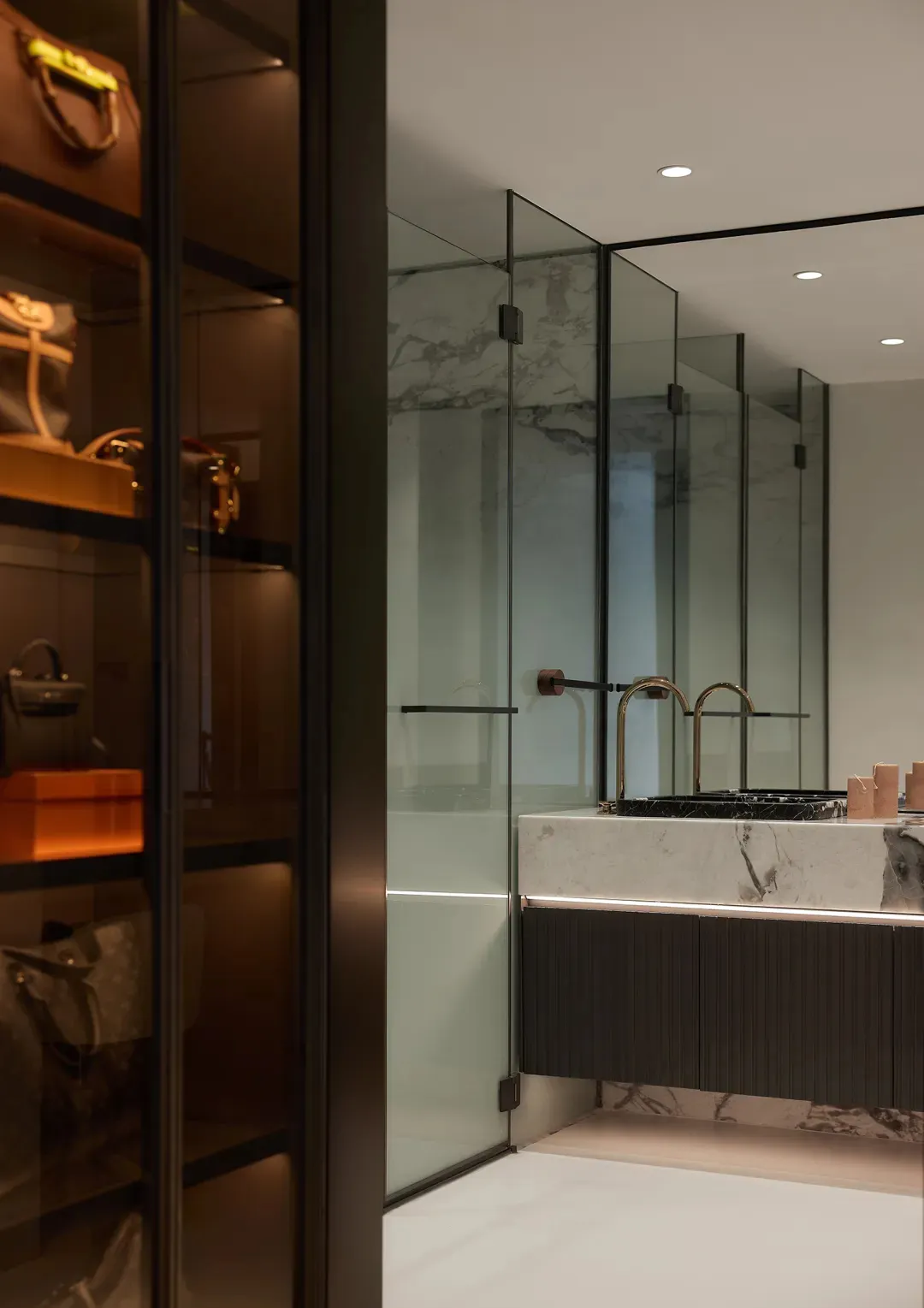 Modern bathroom with marble walls, glass walls, and a white marble countertop