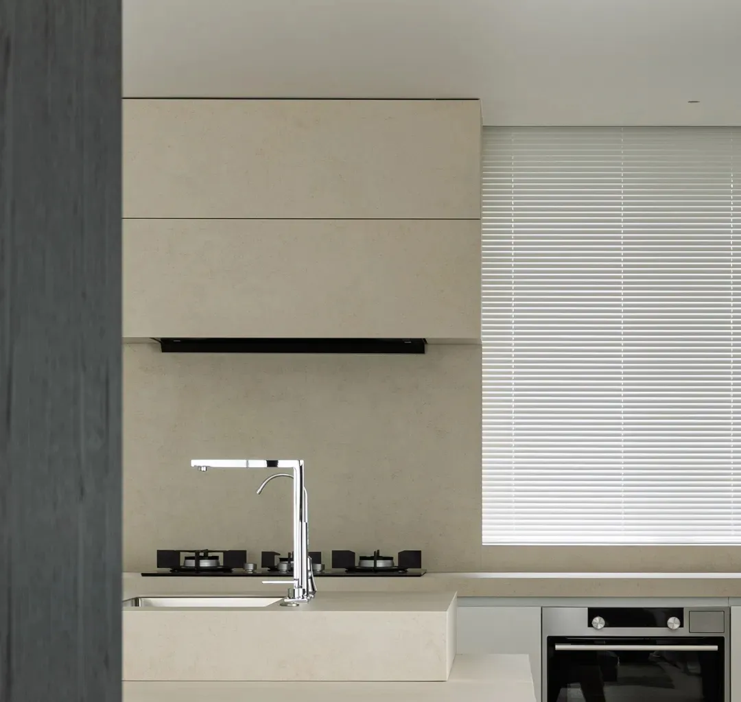 Modern, minimalist kitchen with concrete countertops and floor.