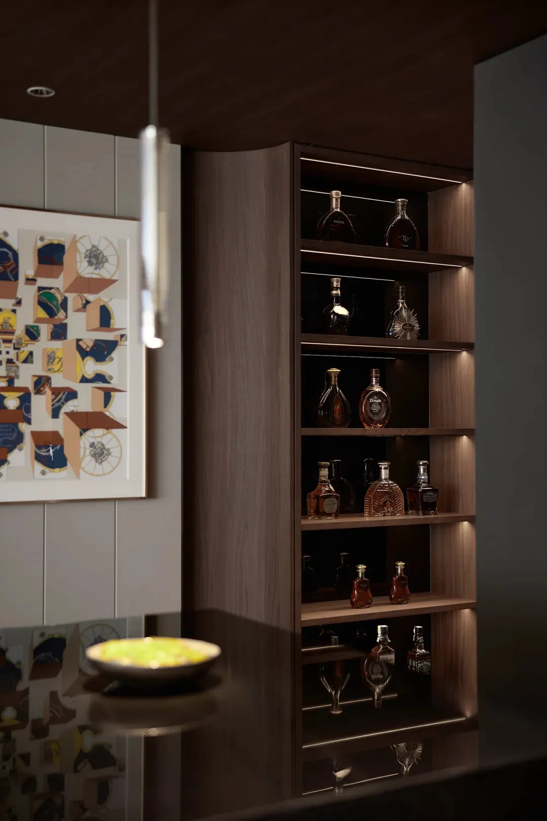 A modern alcohol bar with wooden shelves displaying various bottles of liquor.