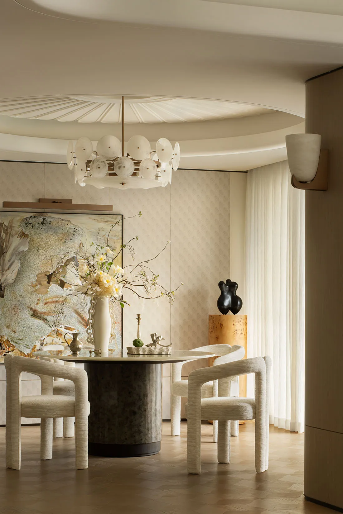 A modern dining room featuring a marble floor and table.