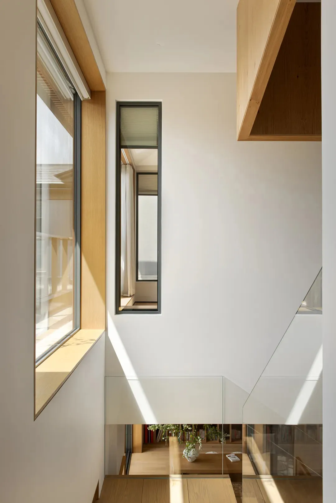 A modern minimalist interior design with concrete, glass, and wooden elements.
