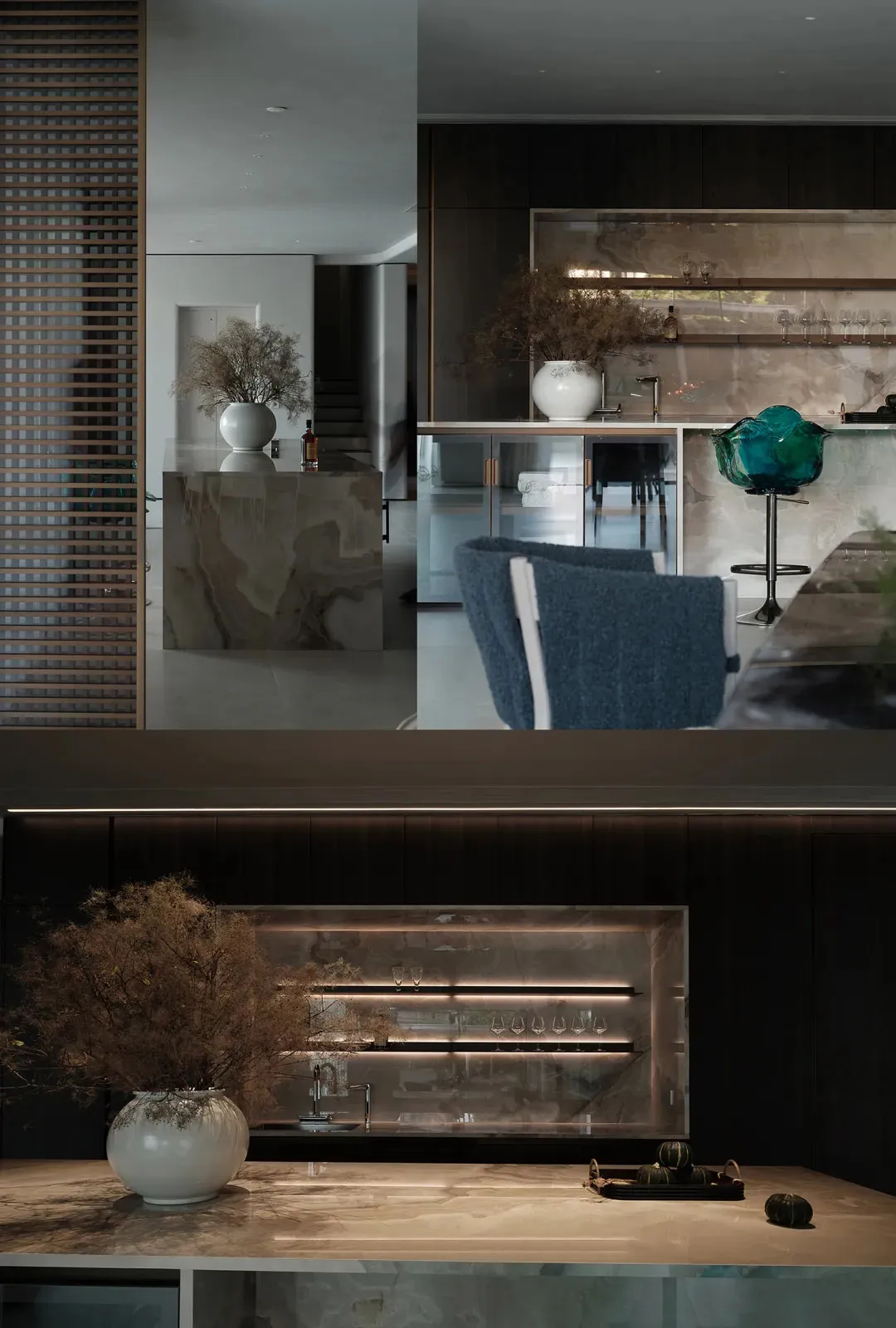 Modern kitchen featuring marble countertops and concrete elements, including a sleek bar counter and stylish seating.