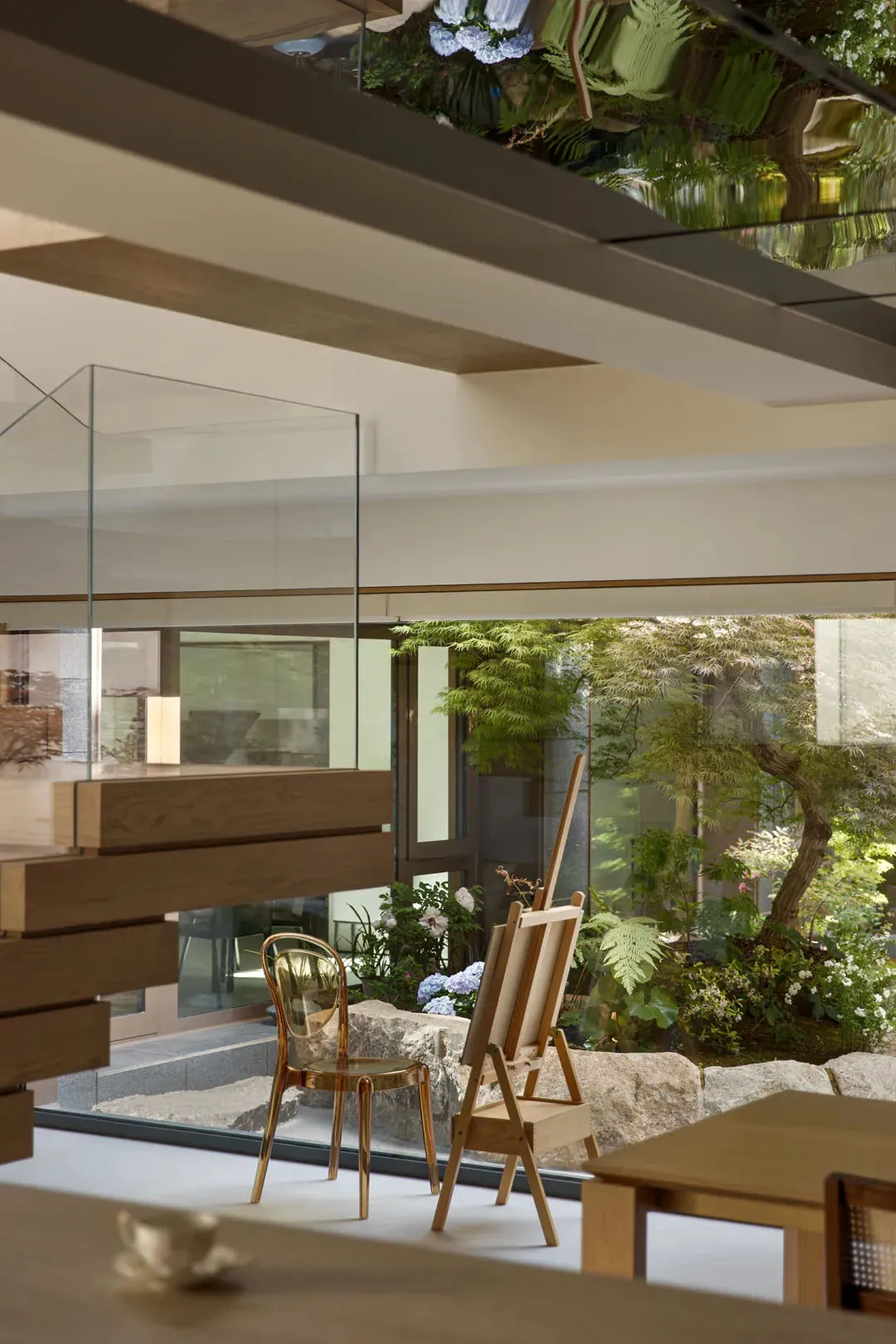 Interior design featuring contemporary residential space with wooden furniture, glass windows, and concrete elements.