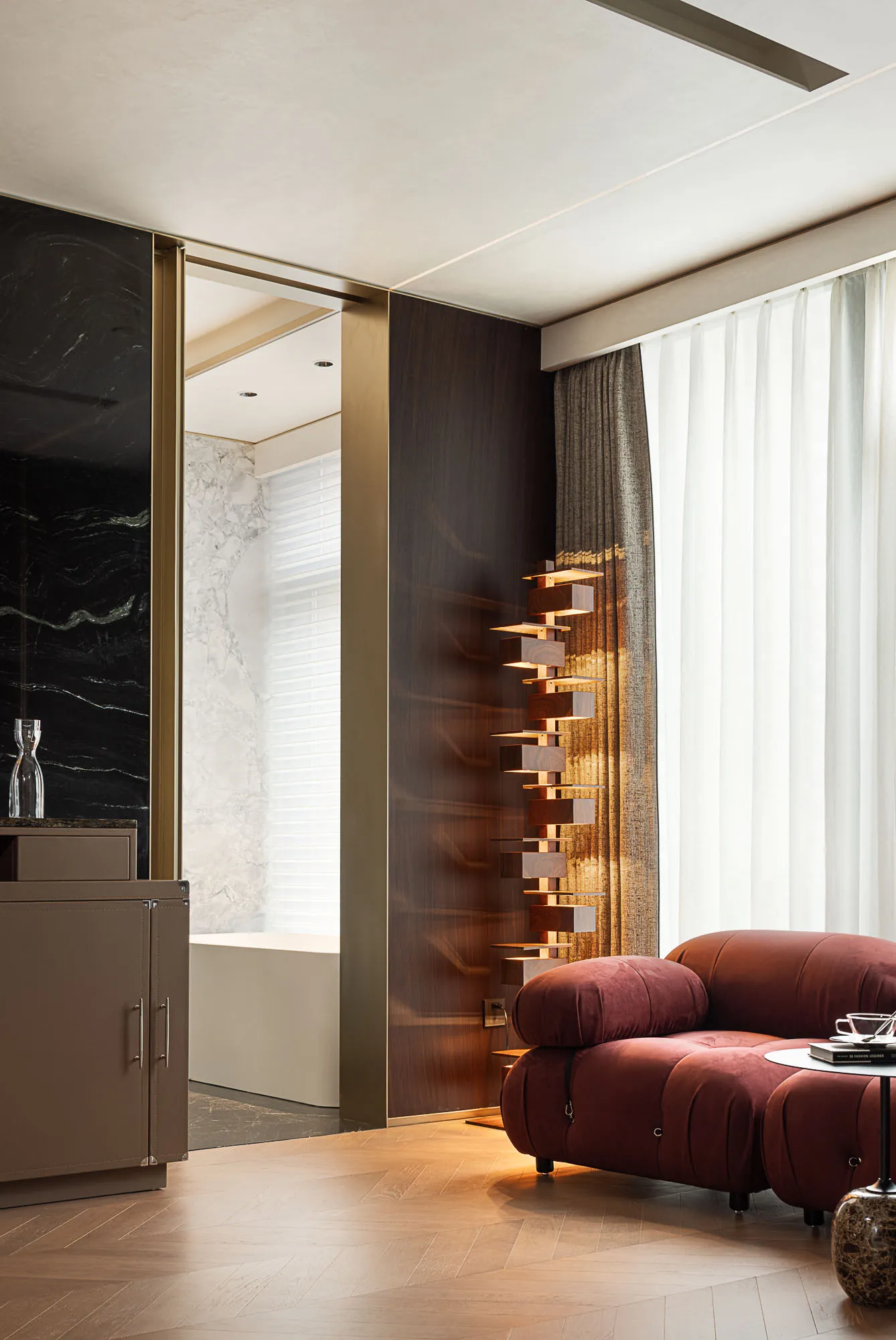 Modern residential interior with marble accents, leather seating, and wooden elements.