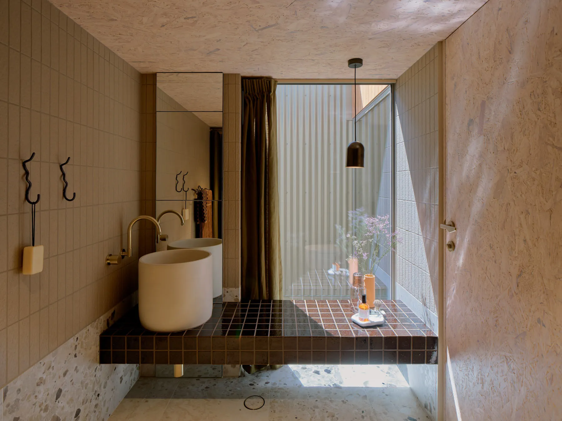 Modern minimalist bathroom featuring concrete tiles and a contemporary sink.