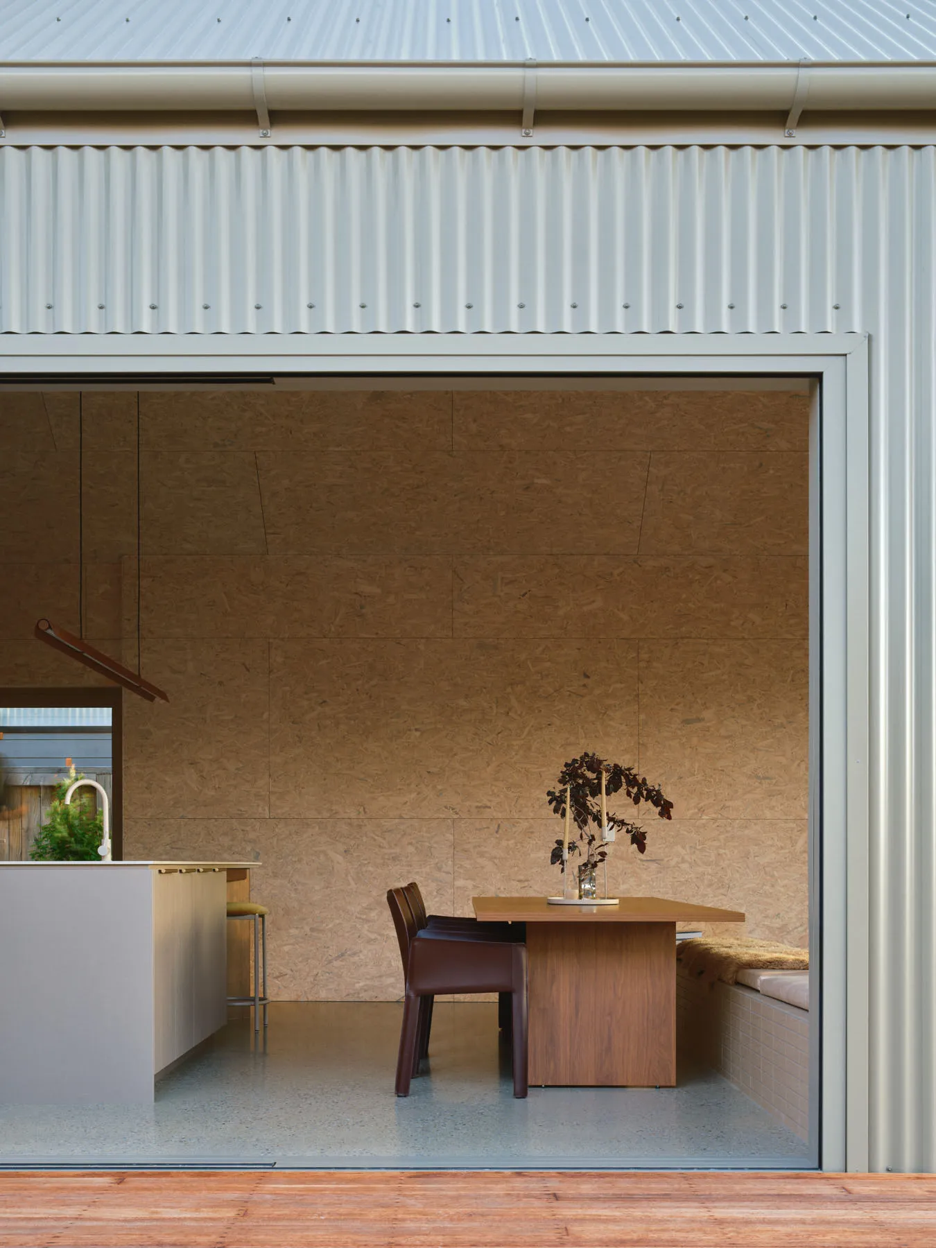 A modern residential kitchen with concrete and wooden surfaces.