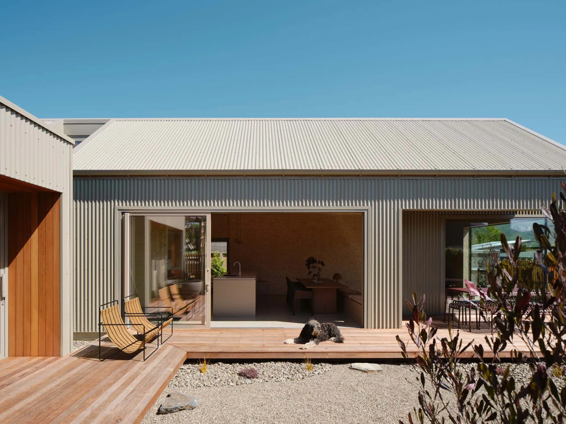 Modern residential exterior with metal-clad panels, featuring a sleek, minimalist design.