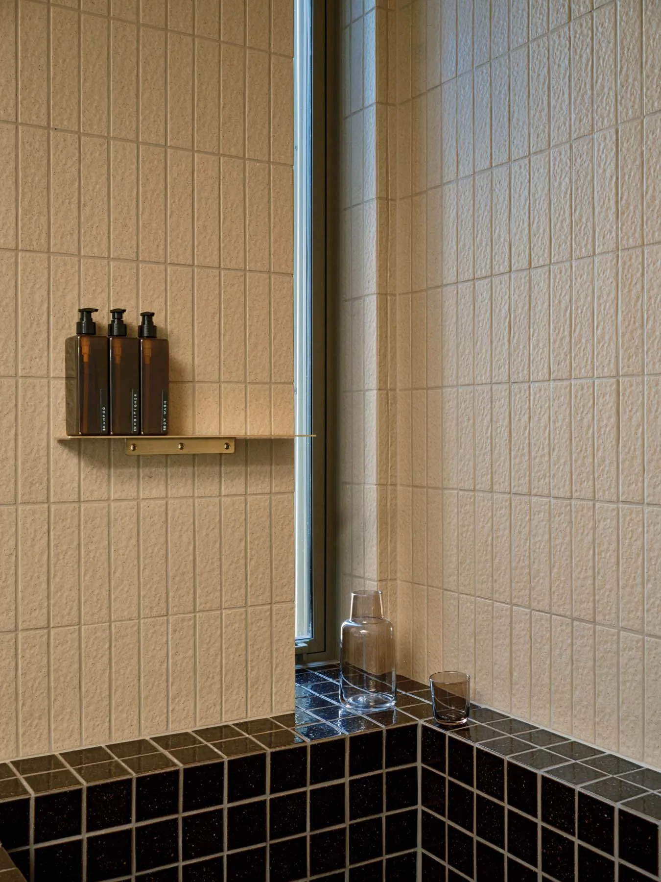 Minimalist bathroom featuring black granite tiles and a modern design aesthetic.