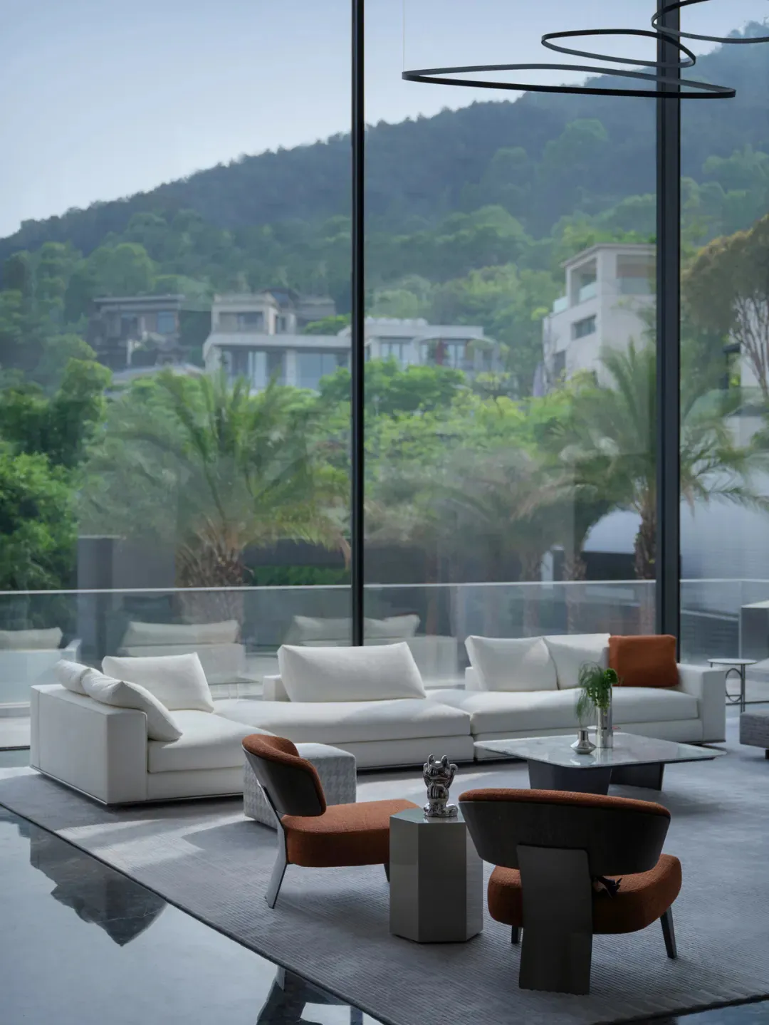 Modern minimalist living room with white walls and black accents.