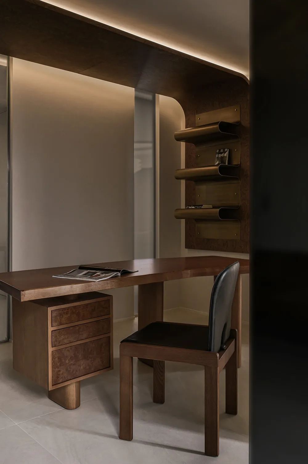 Modern industrial home office featuring a wooden desk with a black leather chair, designed for efficiency and comfort.