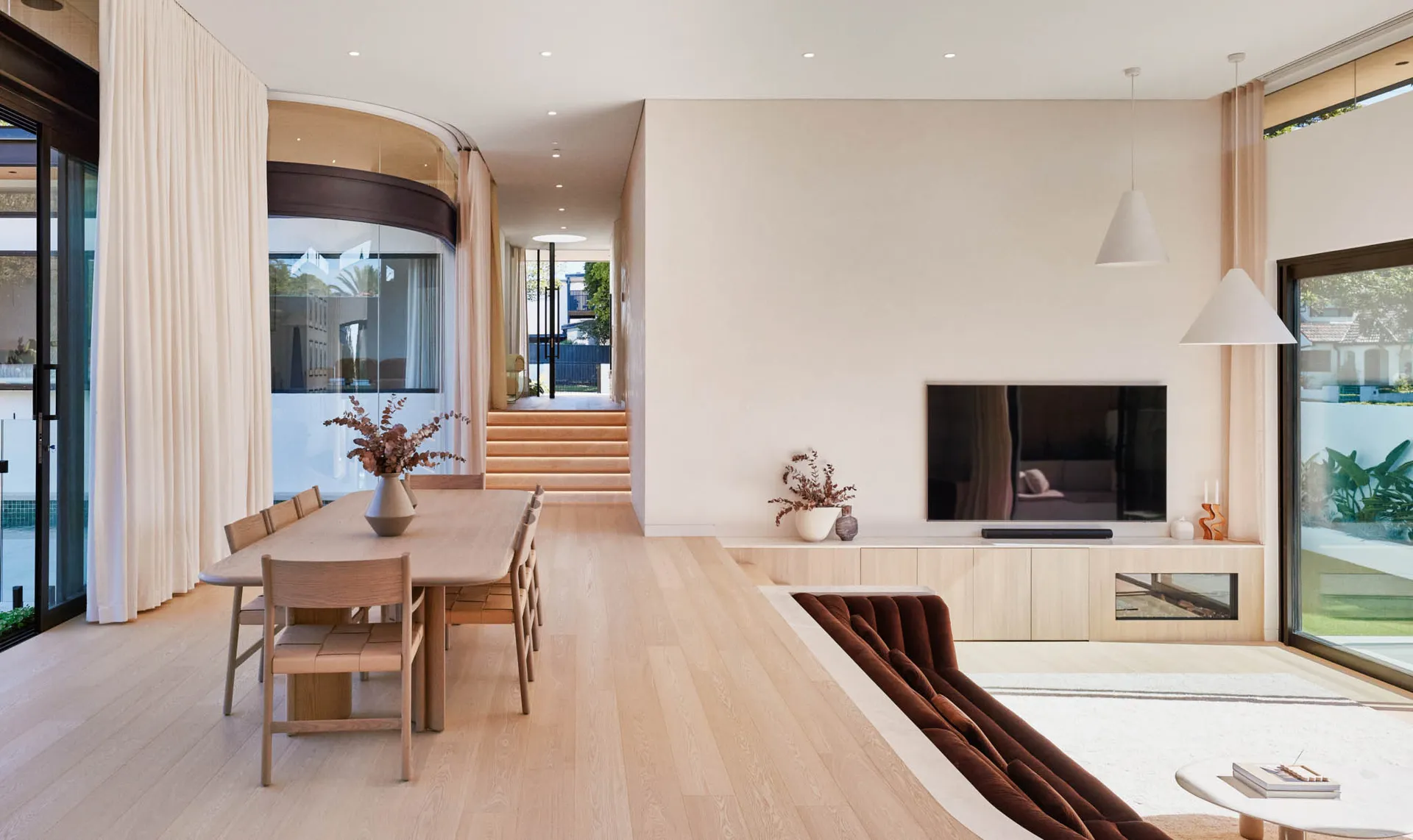 Modern minimalist living room with wooden furniture and glass elements