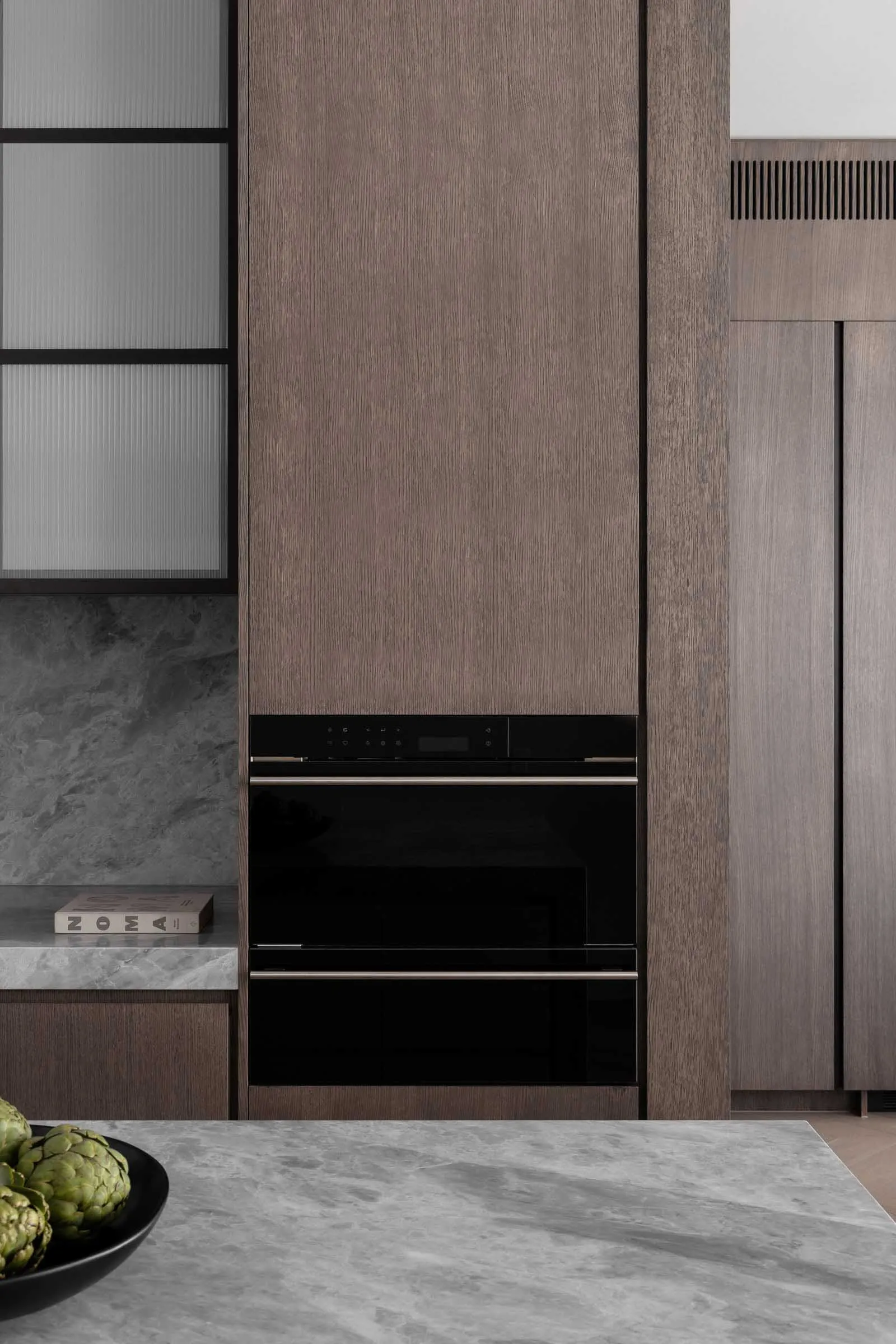 Modern kitchen featuring wood and marble materials