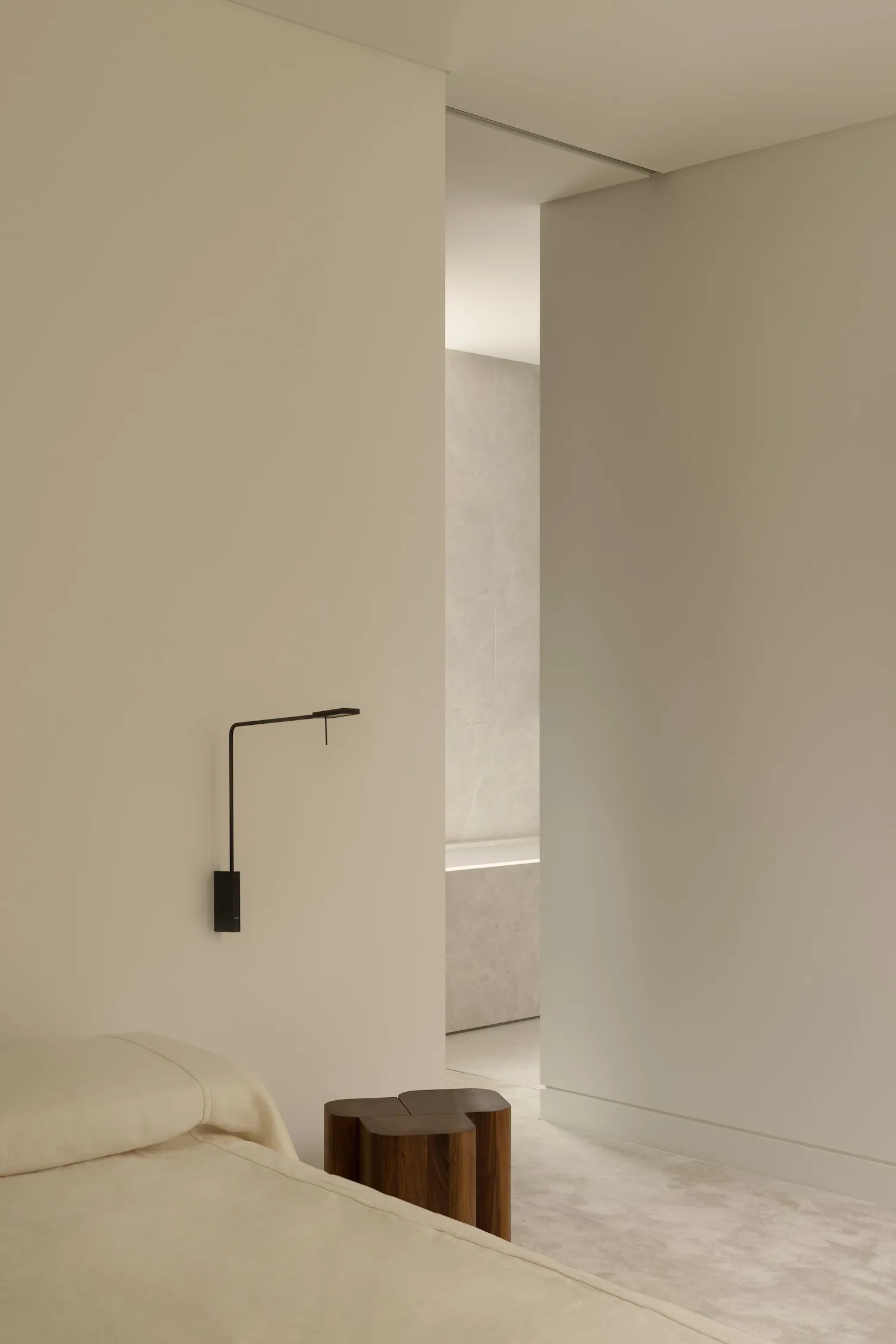 Photograph of a modern bedroom with neutral-toned walls and minimalist decor.