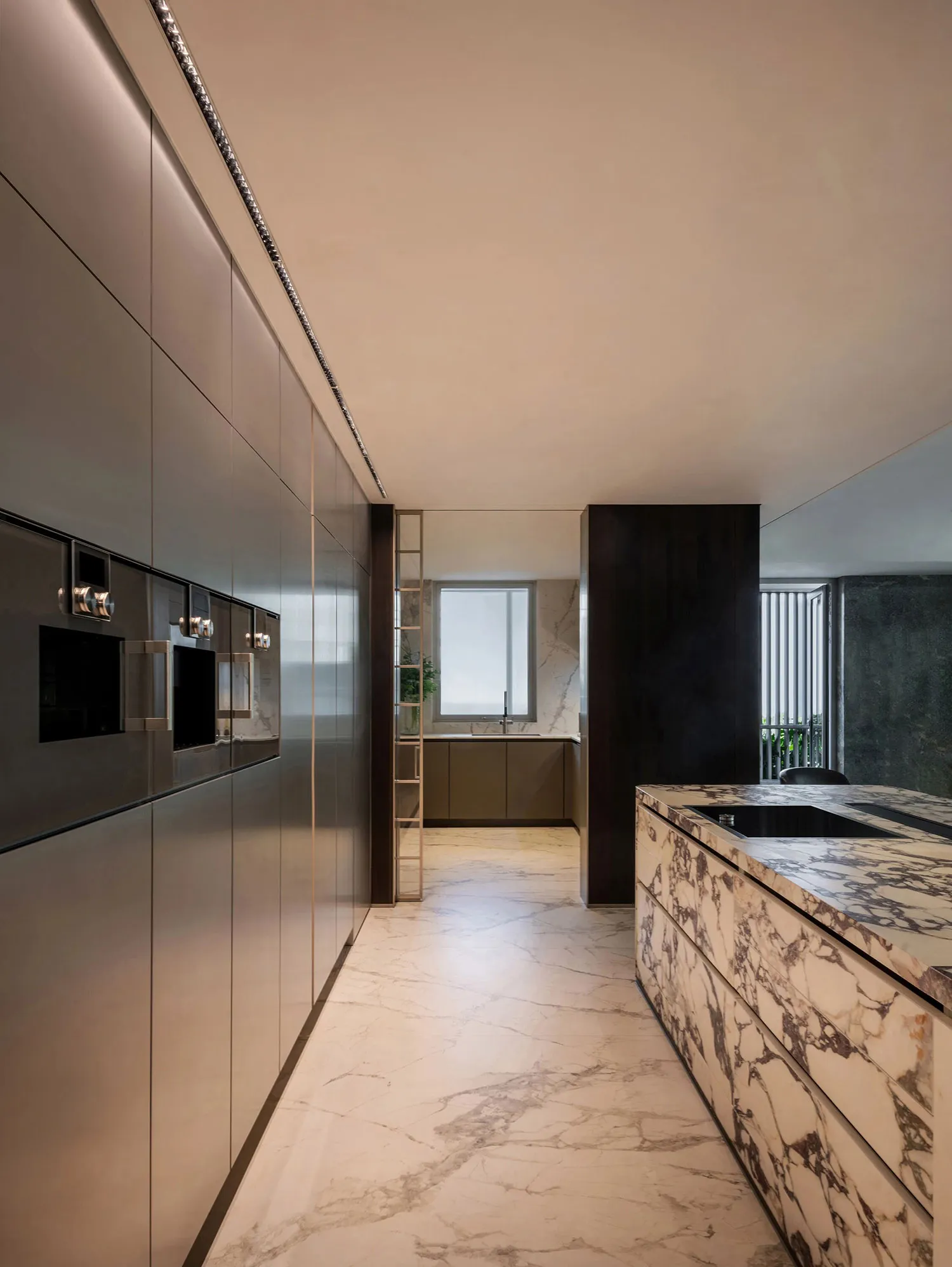 Modern kitchen with marble countertops and floor, sleek design elements.
