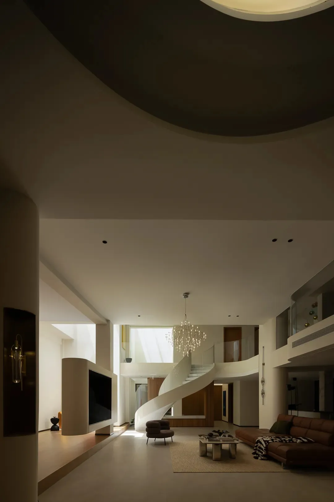 A modern minimalist living room with a spiral staircase, large windows, and a neutral color palette.
