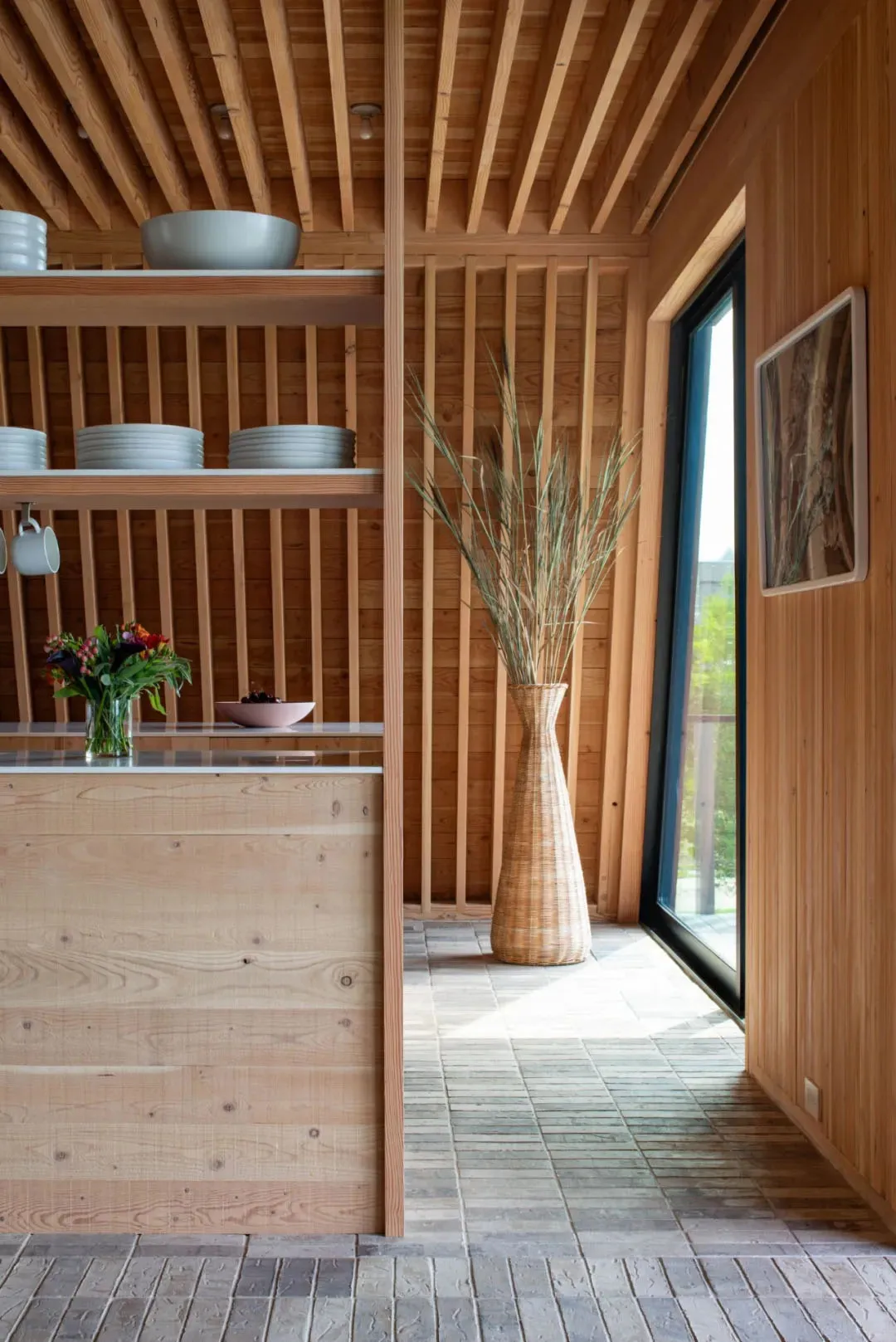 Modern minimalistic kitchen with wooden surfaces and versatile shelves.