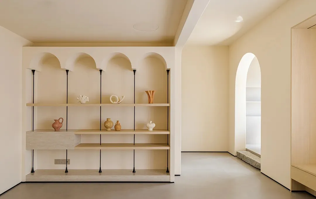A modern shelf display featuring objects on walnut and concrete shelves with black accents.