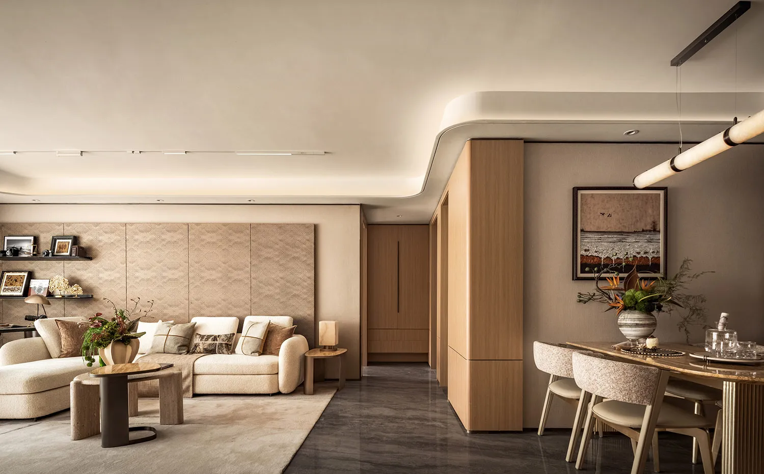 A modern living and dining space featuring wooden accents and neutral tones.