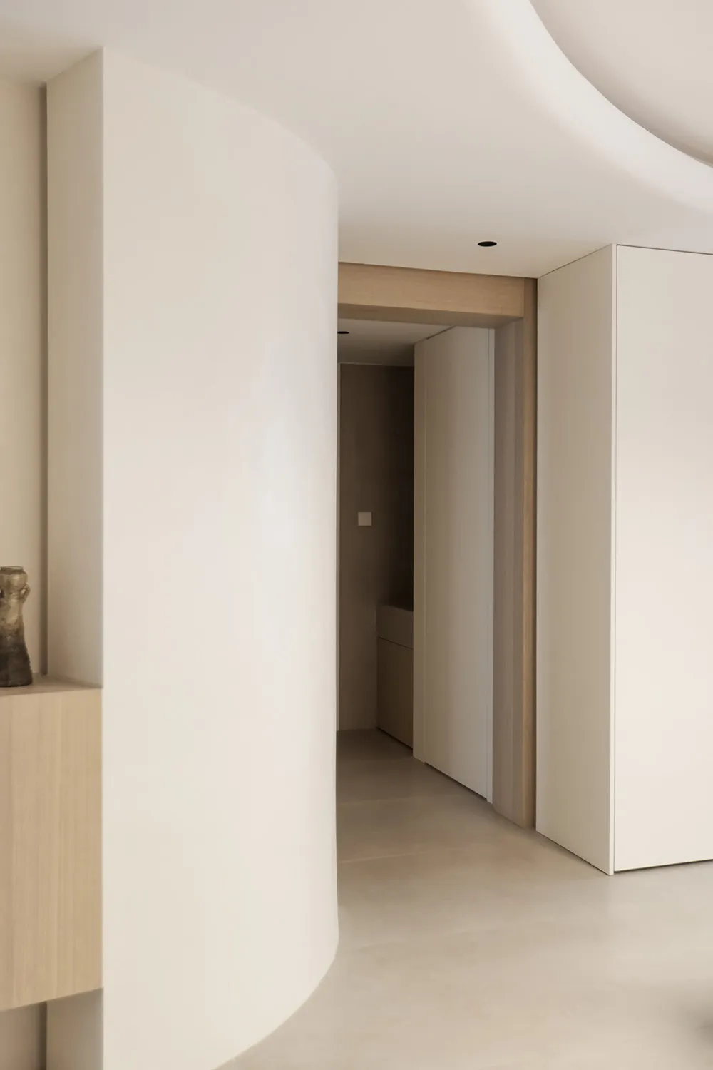 Minimalist design featuring a modern interior space with light-colored concrete walls and floors.