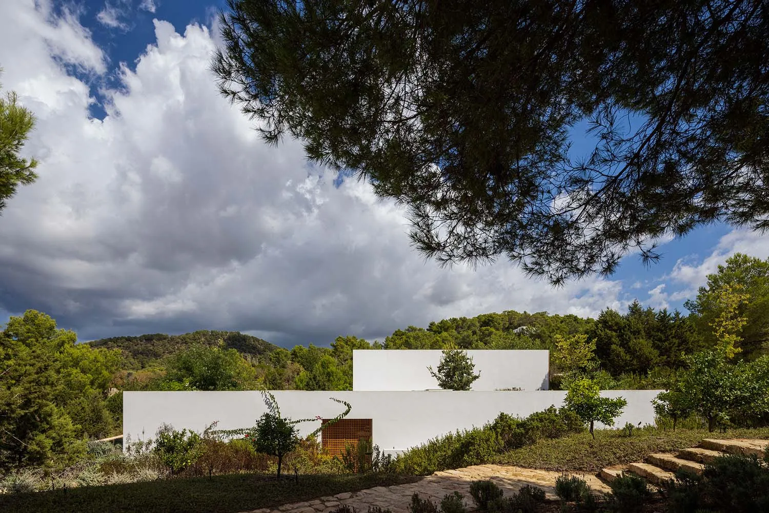 A modern residential house extension featuring white rendered concrete walls.