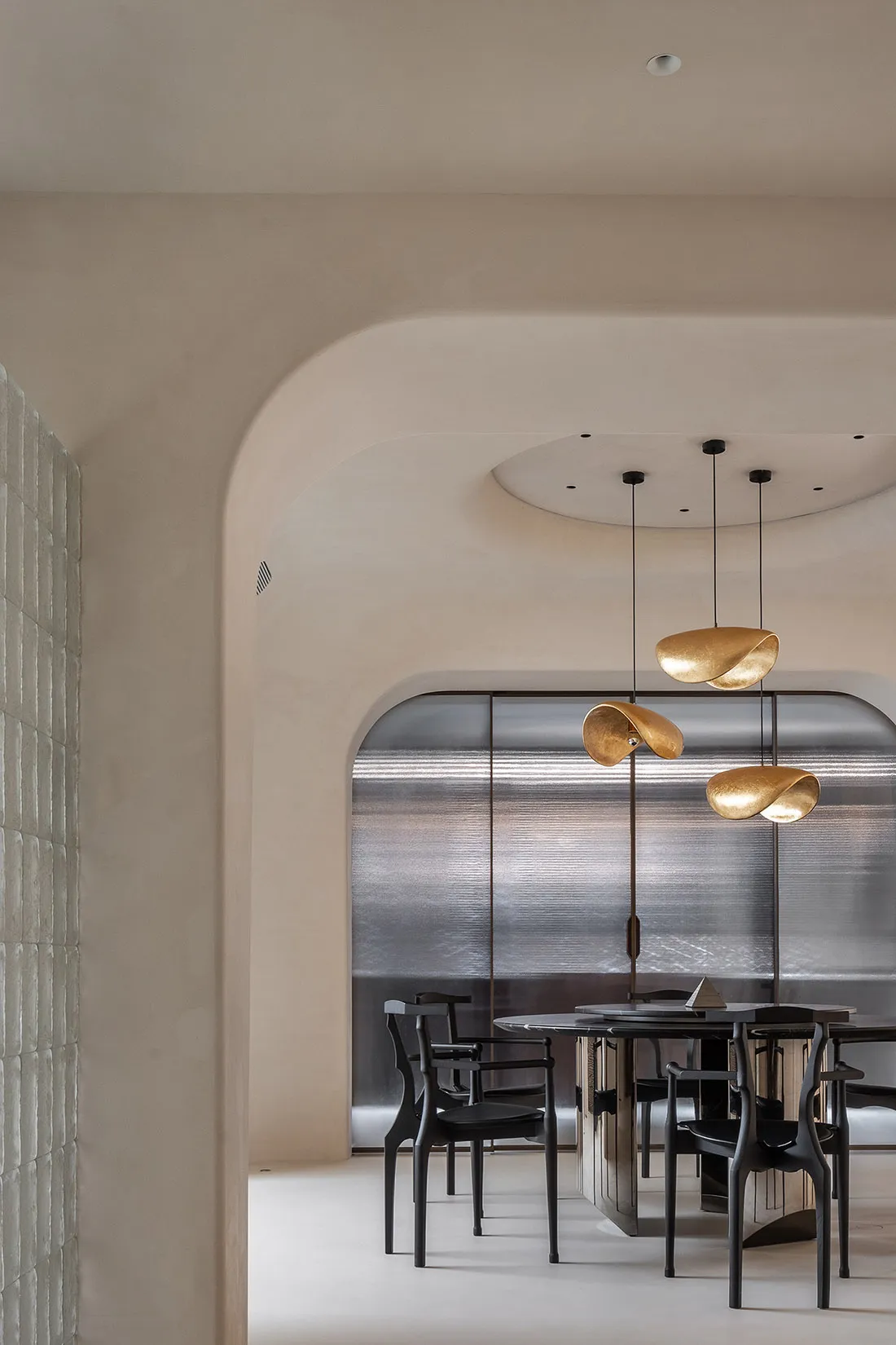 Modern interior design featuring contemporary metal lighting fixtures with curved designs.