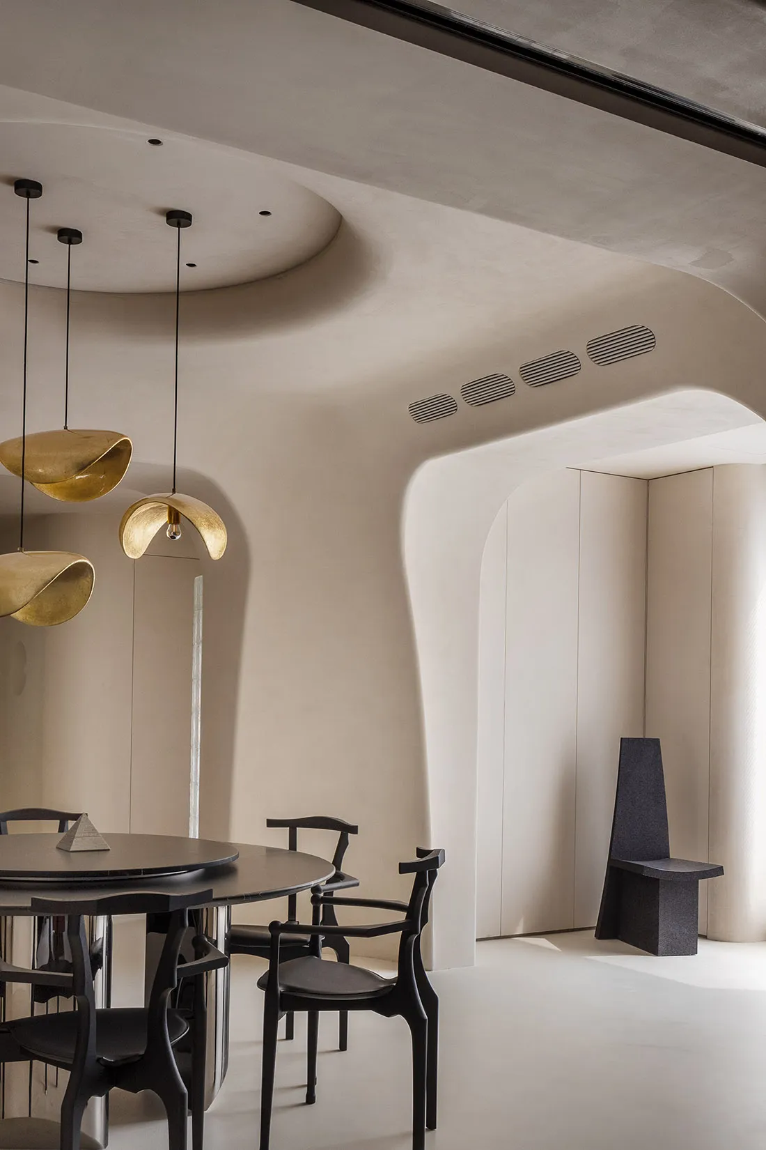 Modern interior design featuring metallic pendant lights.