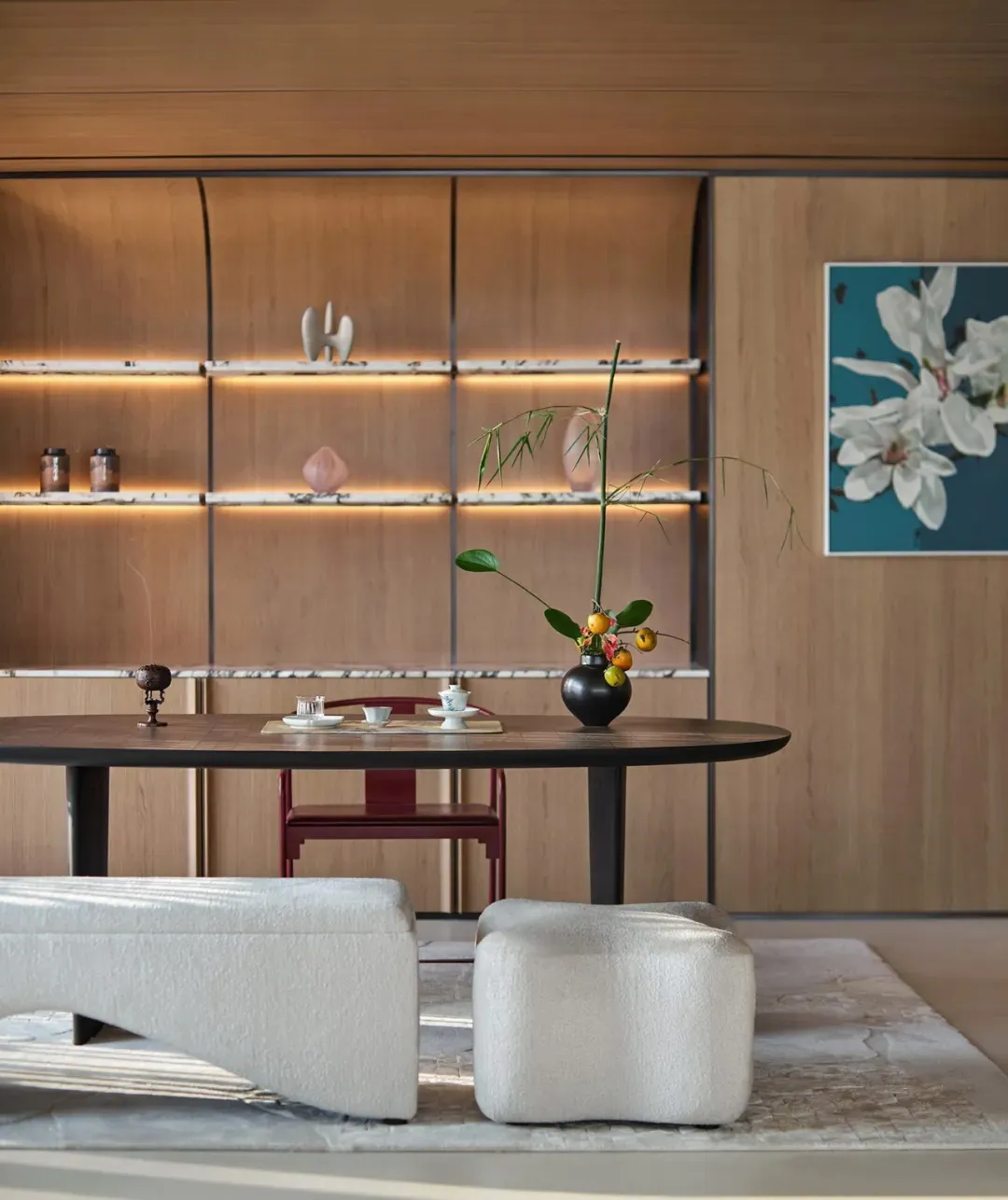 A modern living room with wooden furniture and a white ottoman.
