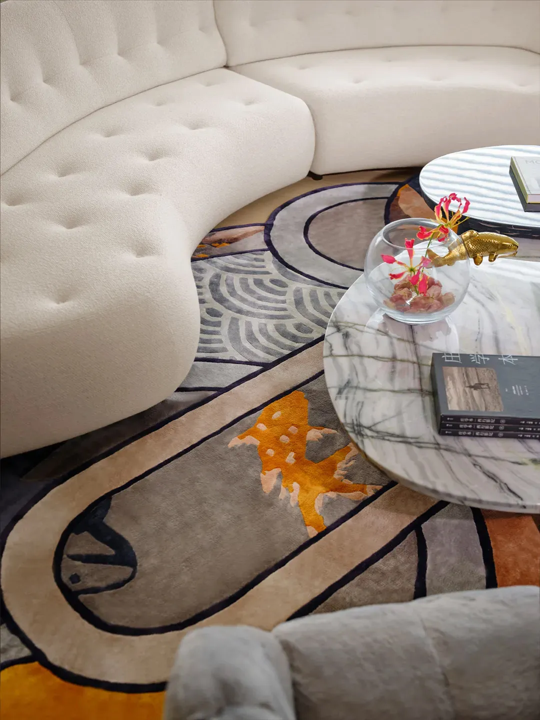 A modern minimalist living room with a white curved sofa and a colorful abstract carpet