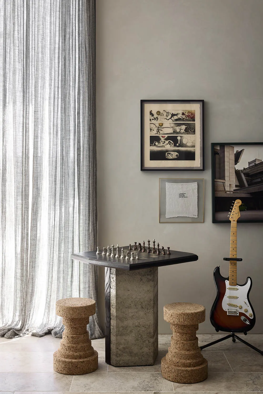 A minimalist game room with a stone table and cork stools.