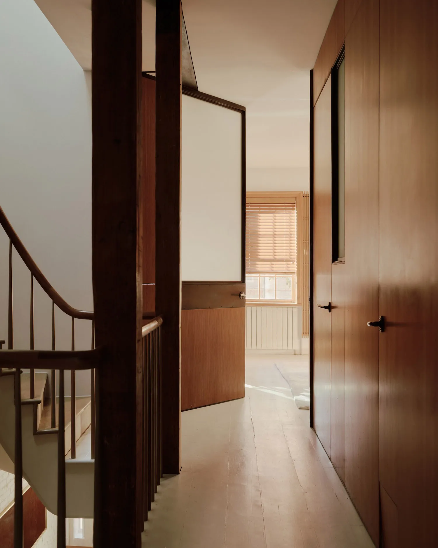 Modern interior with minimalist design, featuring wood finishes.
