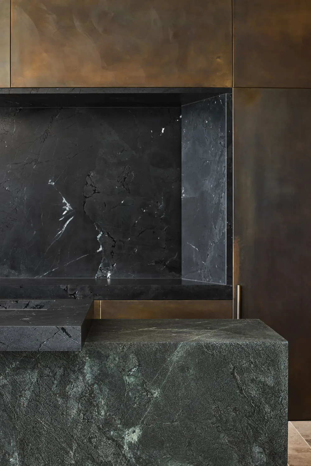 A modern kitchen featuring a black marble countertop and a black marble backsplash.