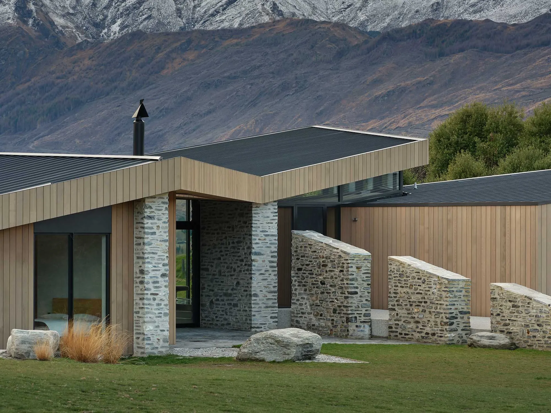 A modern residential house featuring wooden and stone materials.