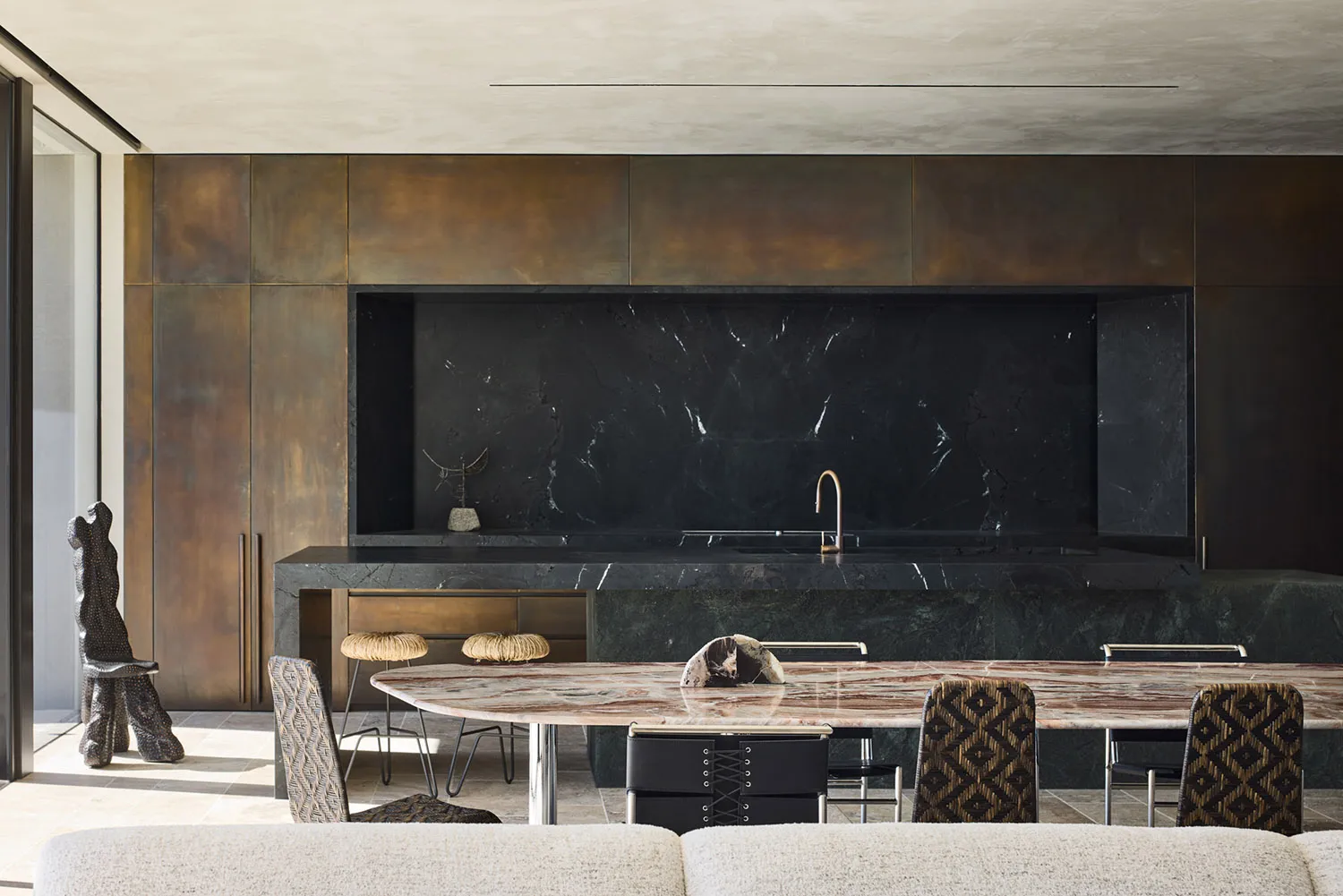 Modern residential kitchen featuring black marble countertops and backsplash