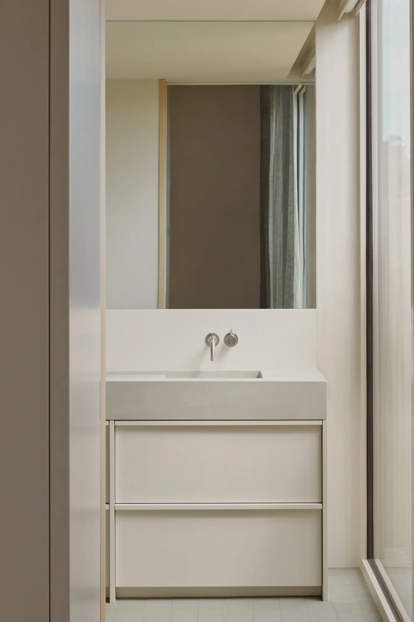 Modern bathroom featuring concrete vanity and metallic faucet