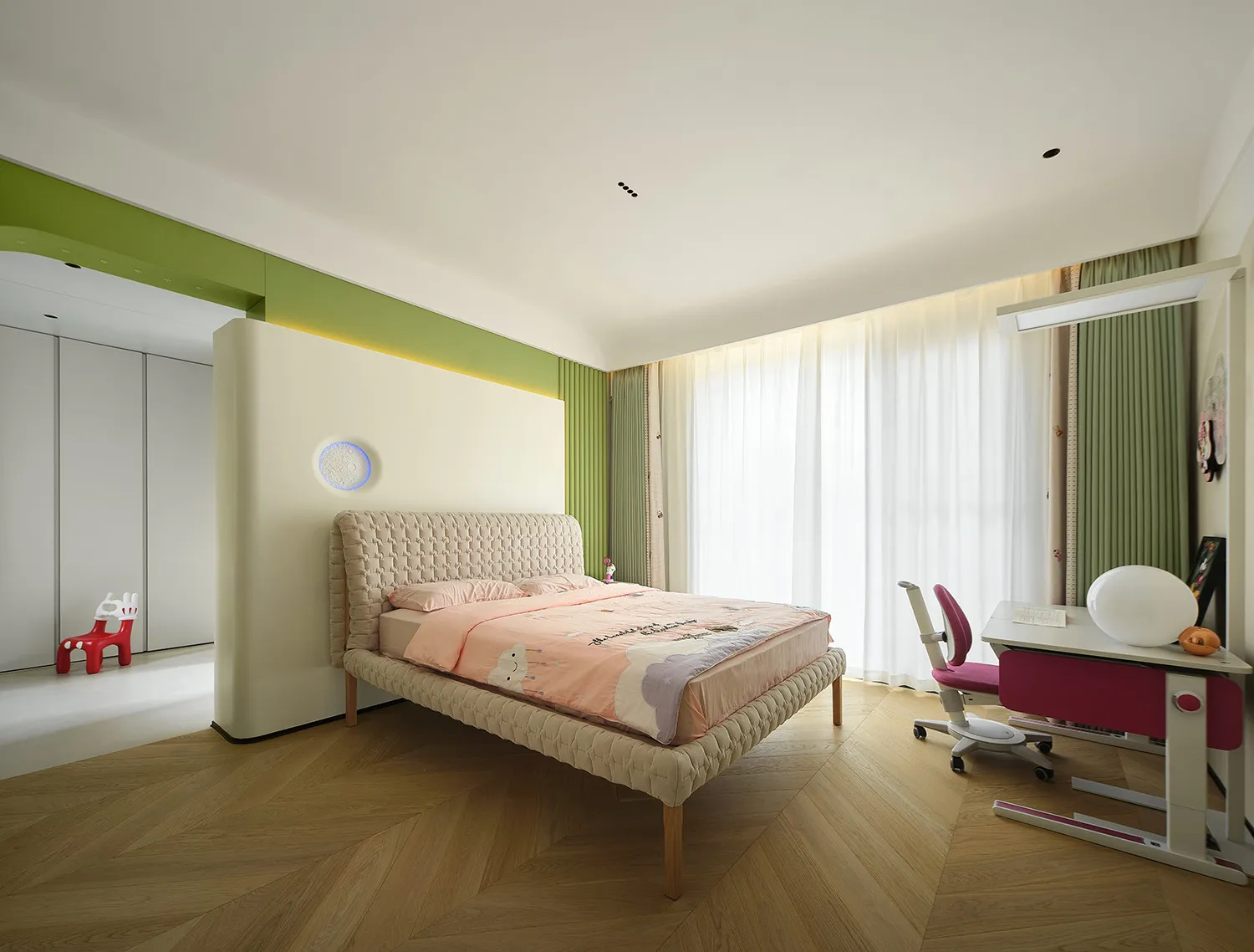 Modern bedroom with a wooden floor, white furniture, and a pink bedspread.