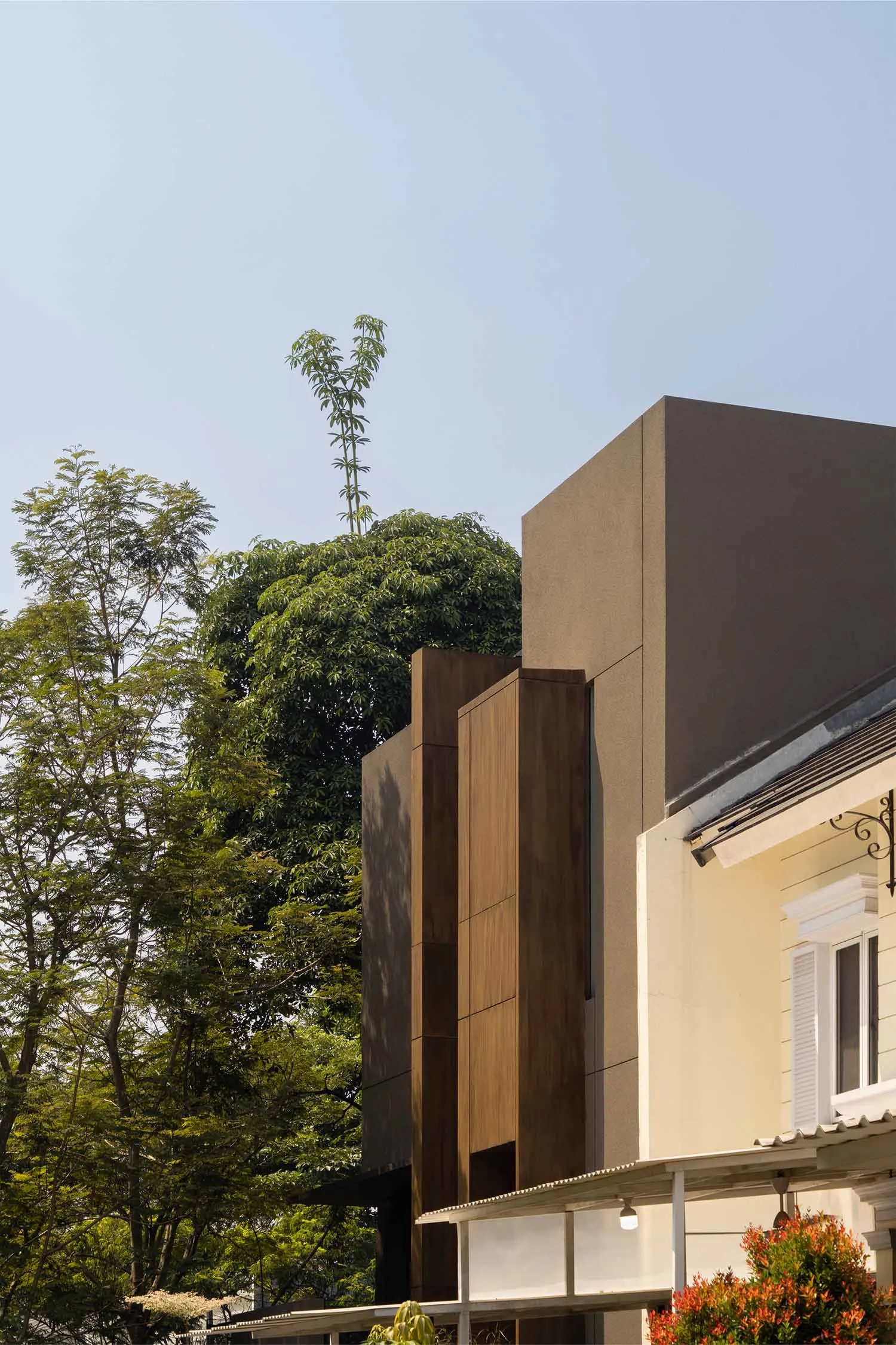 A modern building exterior featuring wooden and concrete materials.