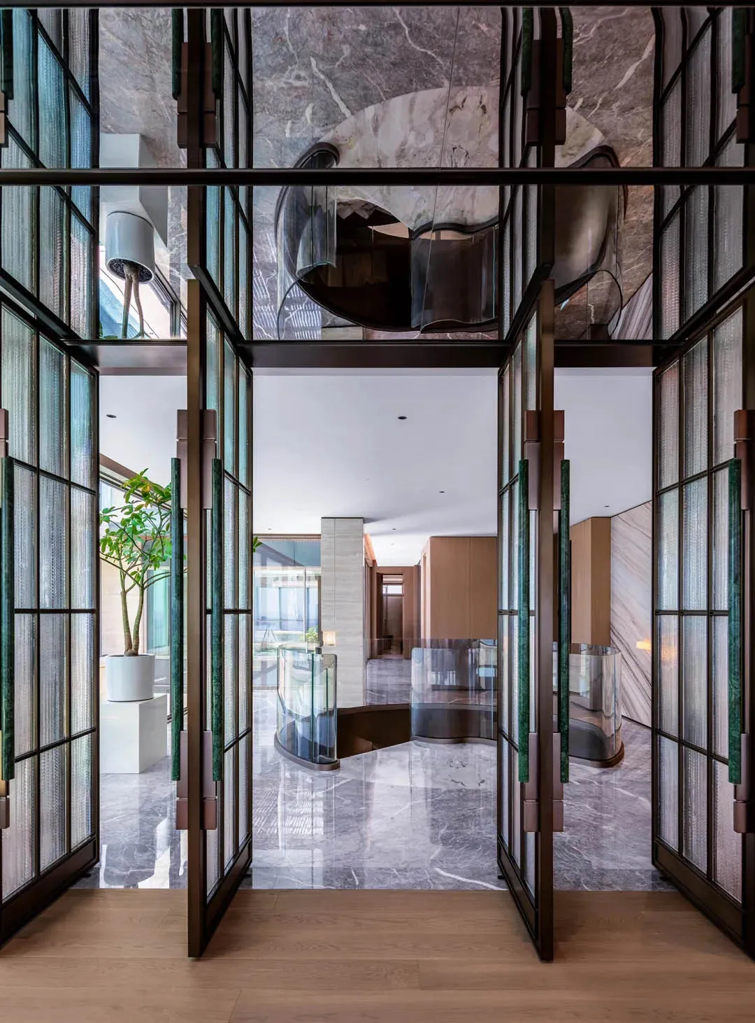 Modern interior design of an entryway featuring marble flooring and walls.