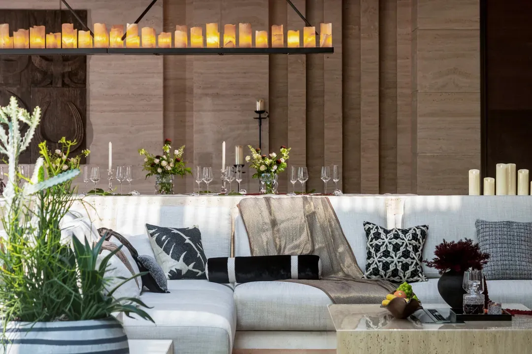 A modern living room featuring luxurious candles, stylish decorations, and comfortable seating arrangements.