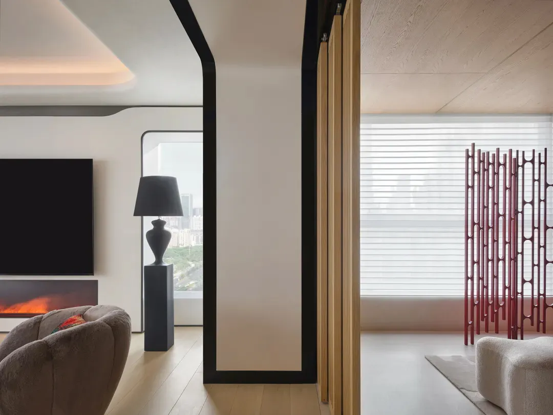 Modern living room featuring a fireplace and minimalist decor, with a view of the city.