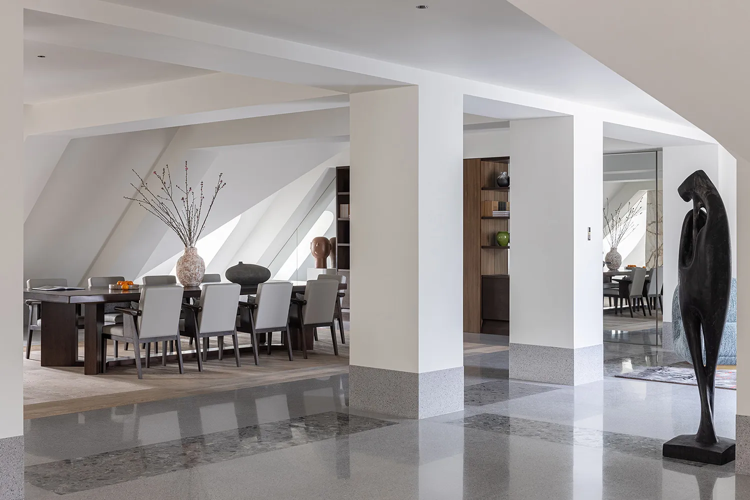A modern residential interior featuring concrete, wood, and marble finishes.