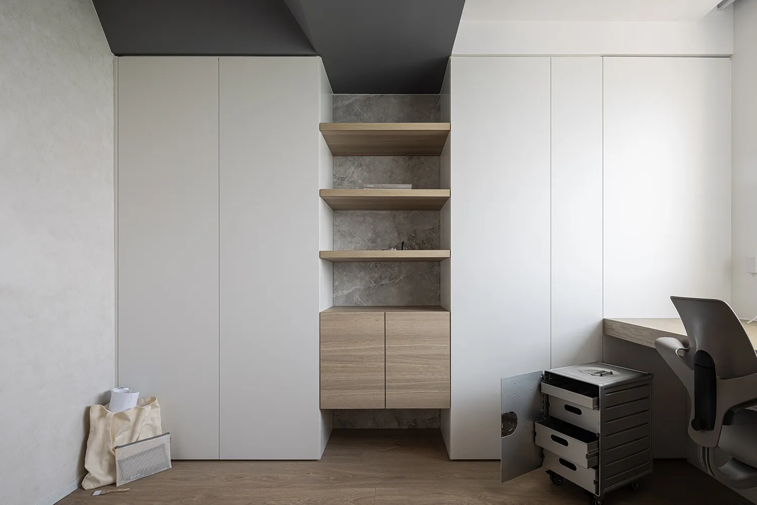 Minimalist home office featuring modern storage solutions with wood, concrete, and metal elements.