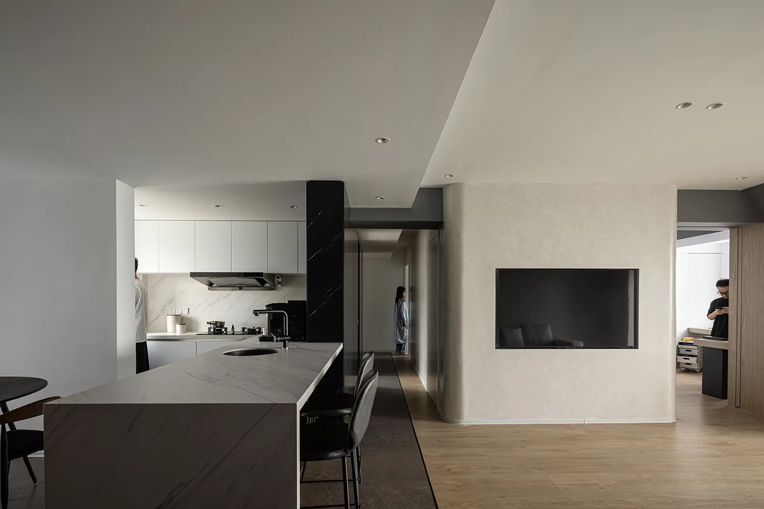 Modern kitchen with marble countertops and concrete accents.