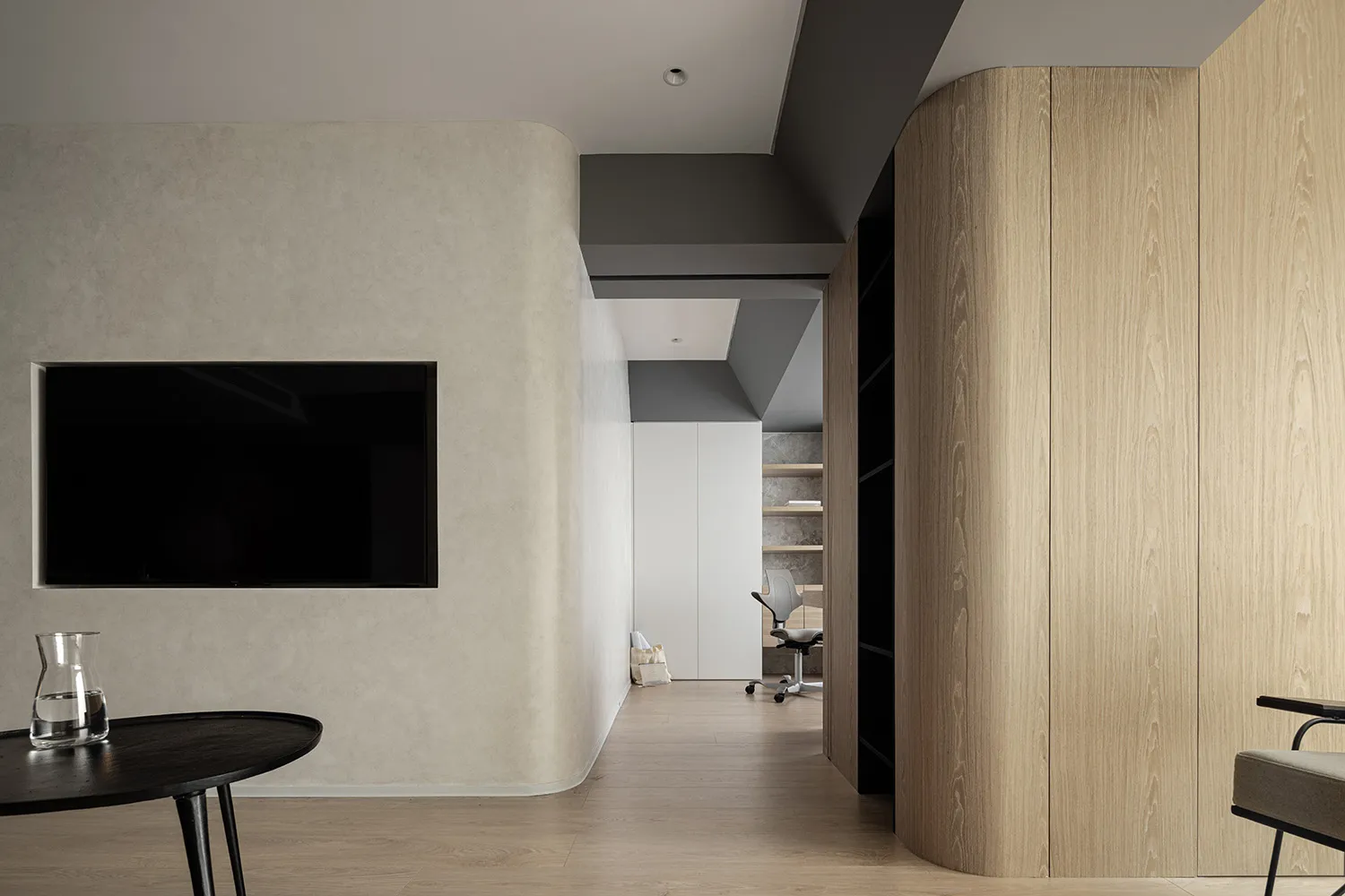 A minimalist office space featuring wood-paneled walls and a simple, sleek design.