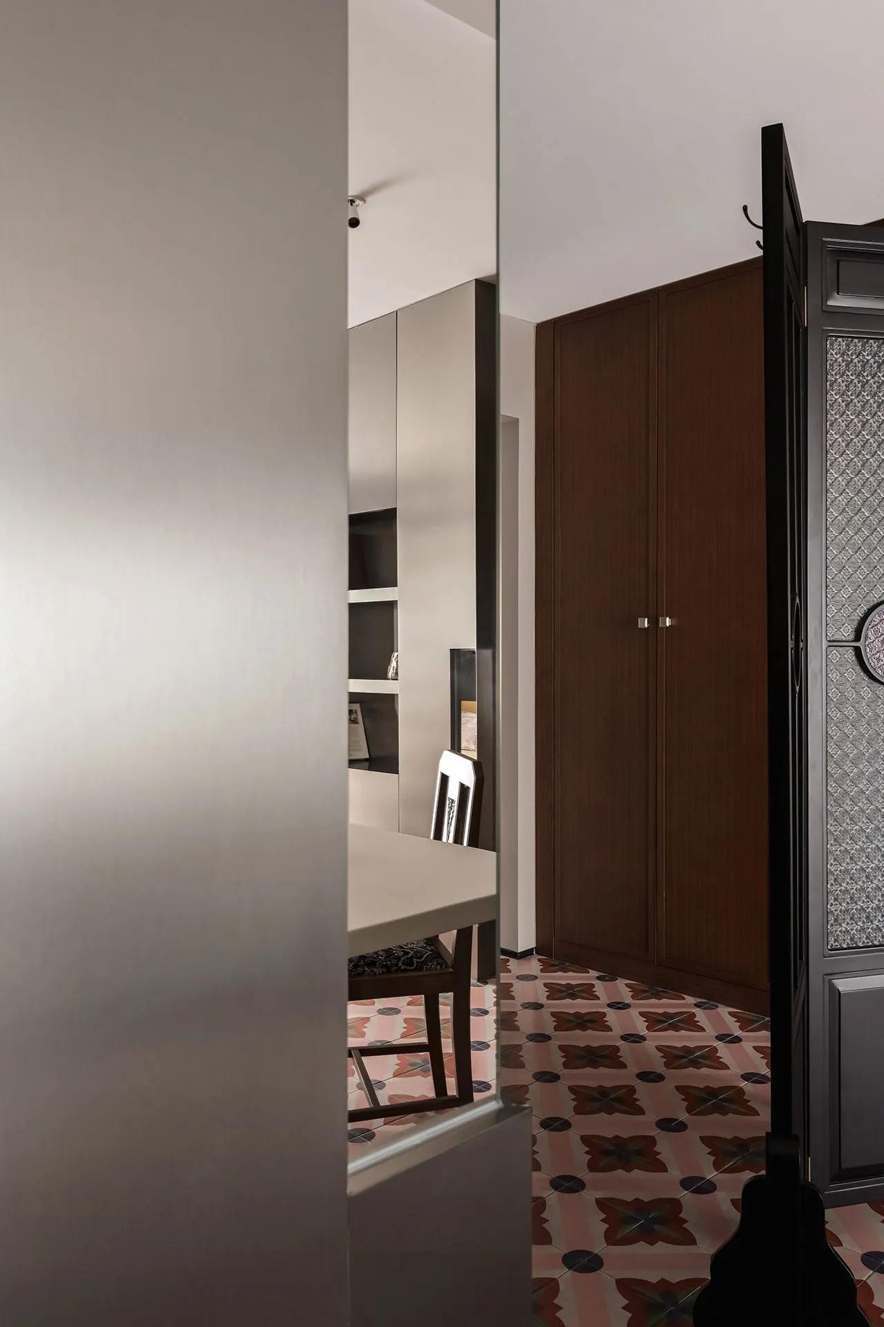 Modern dining room featuring a table and chairs with cement tiles flooring.