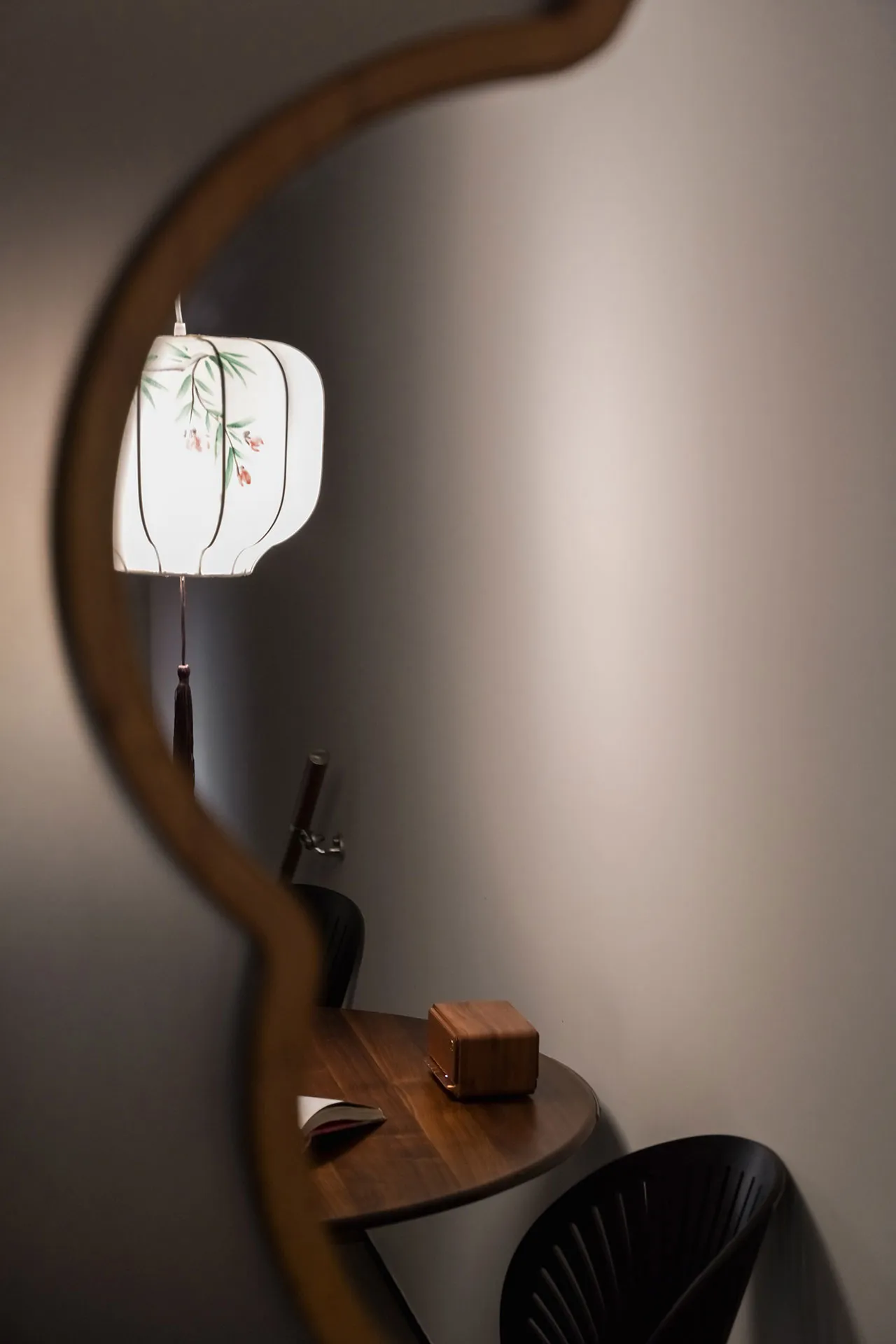 A study space featuring a wooden table with a lamp and an open book.