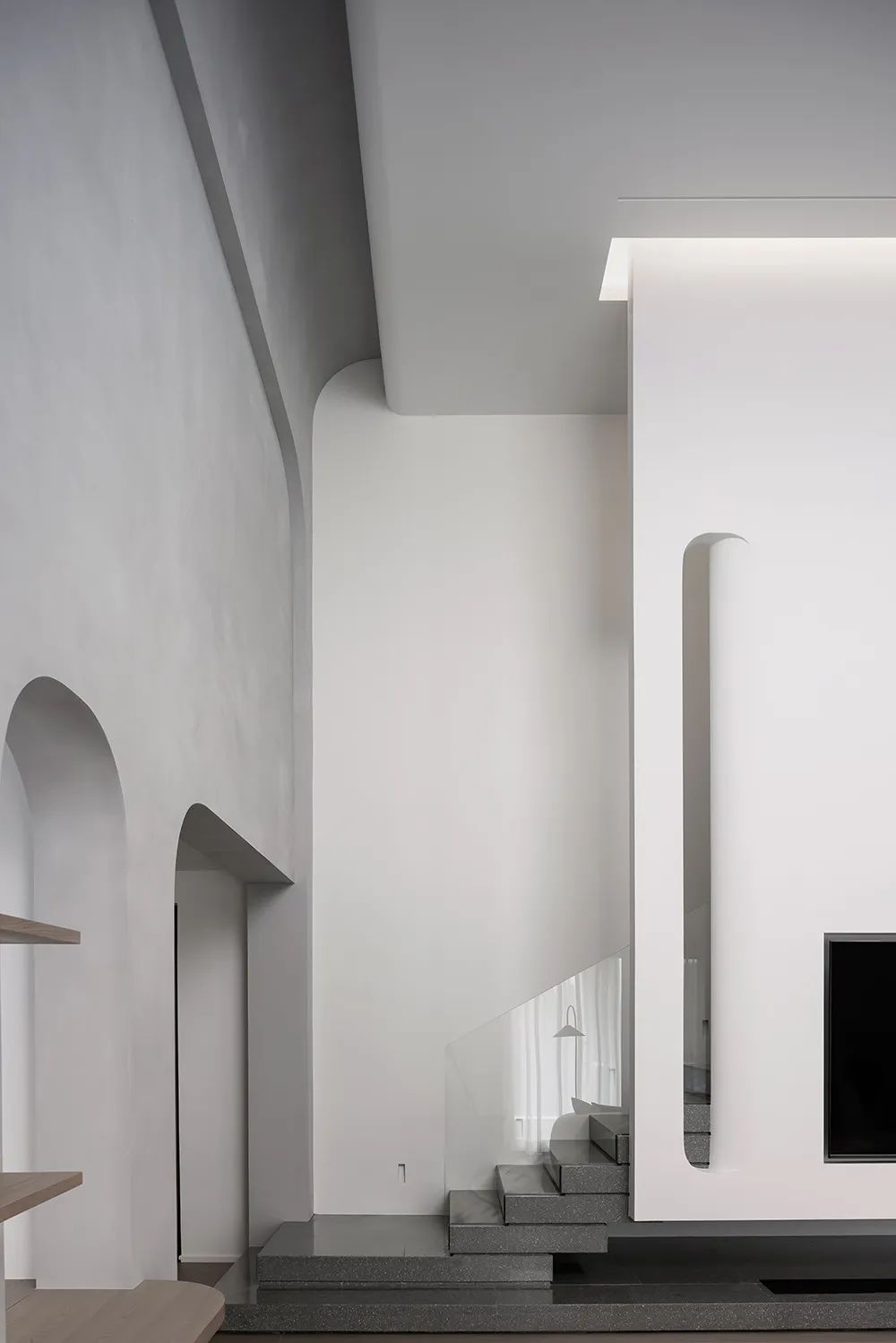 Modern interior design featuring concrete, glass, and wooden elements.