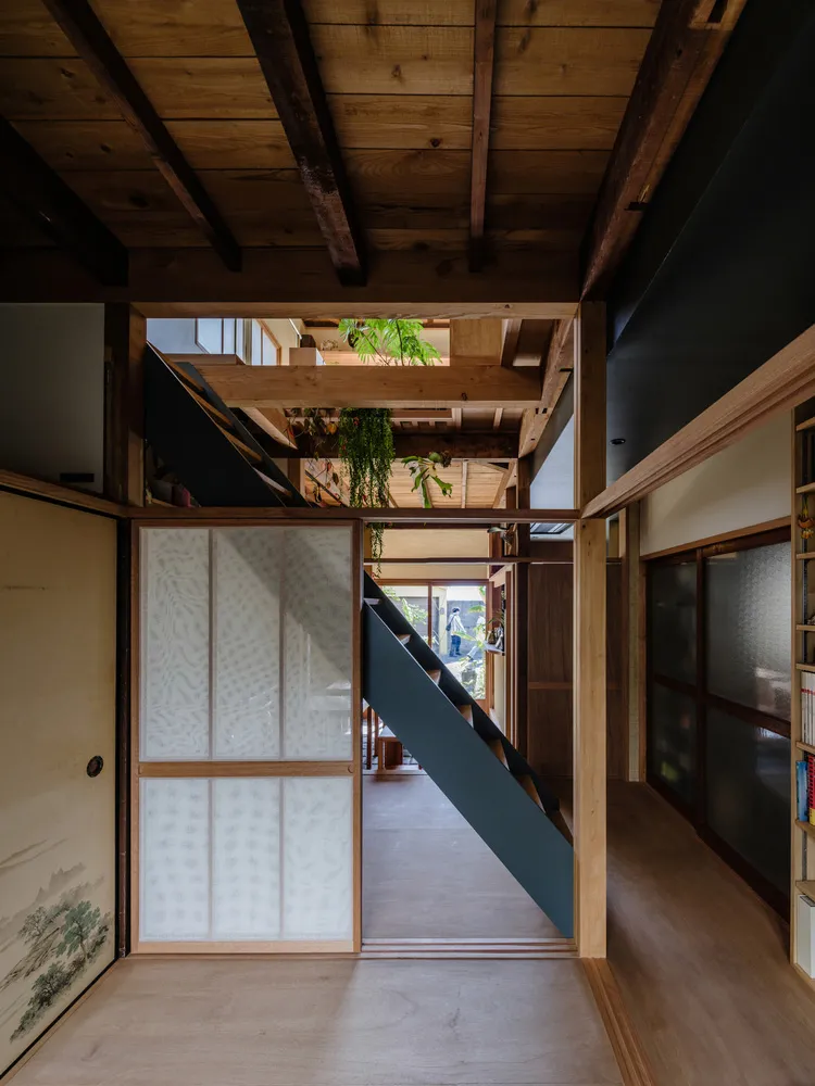 A minimalist wooden interior with a staircase and other architectural elements.
