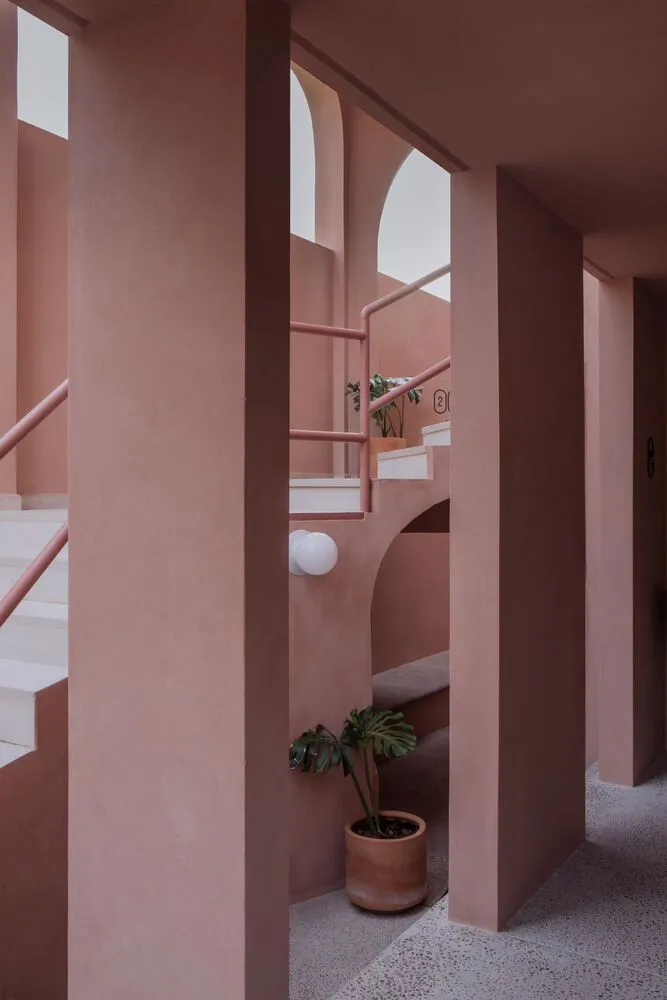 A modern residential interior with a concrete stairway and white accents.