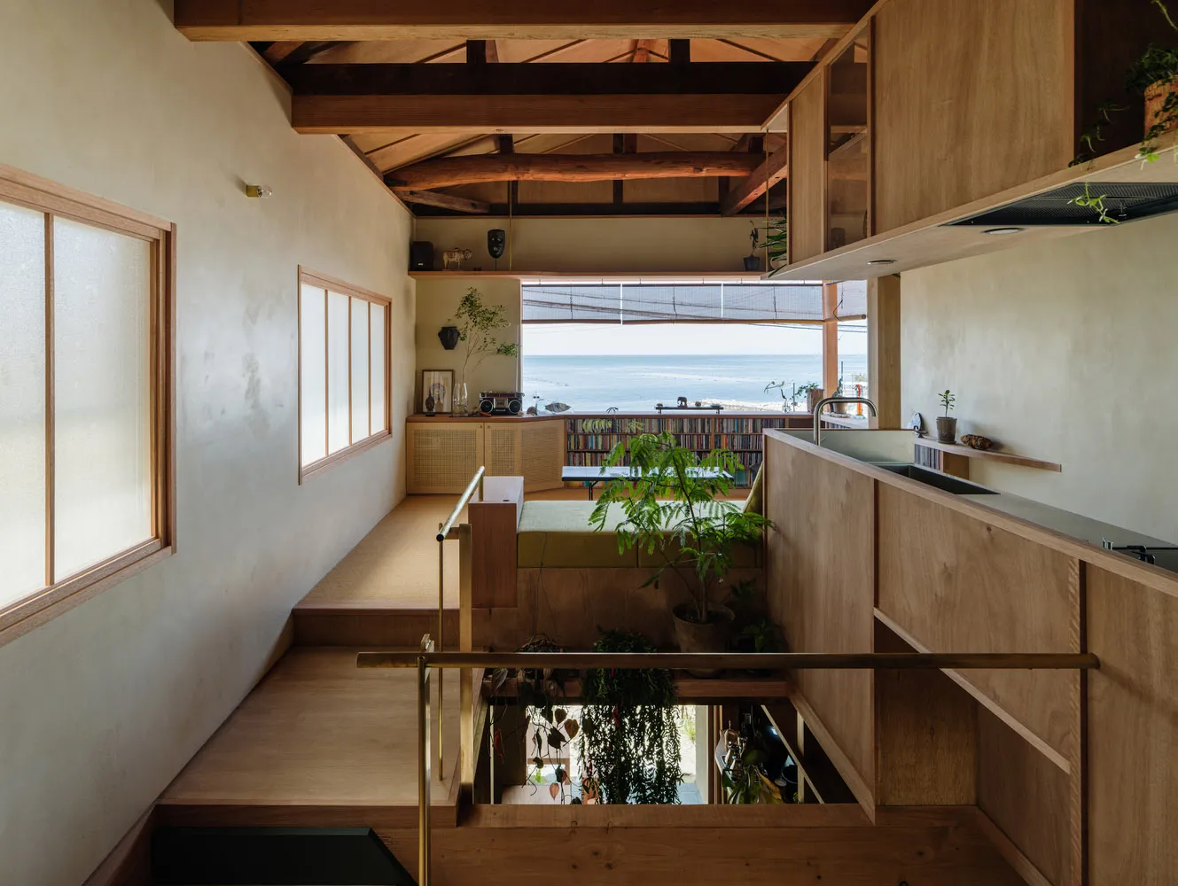 A modern floating house with wooden interior and a view of the ocean.